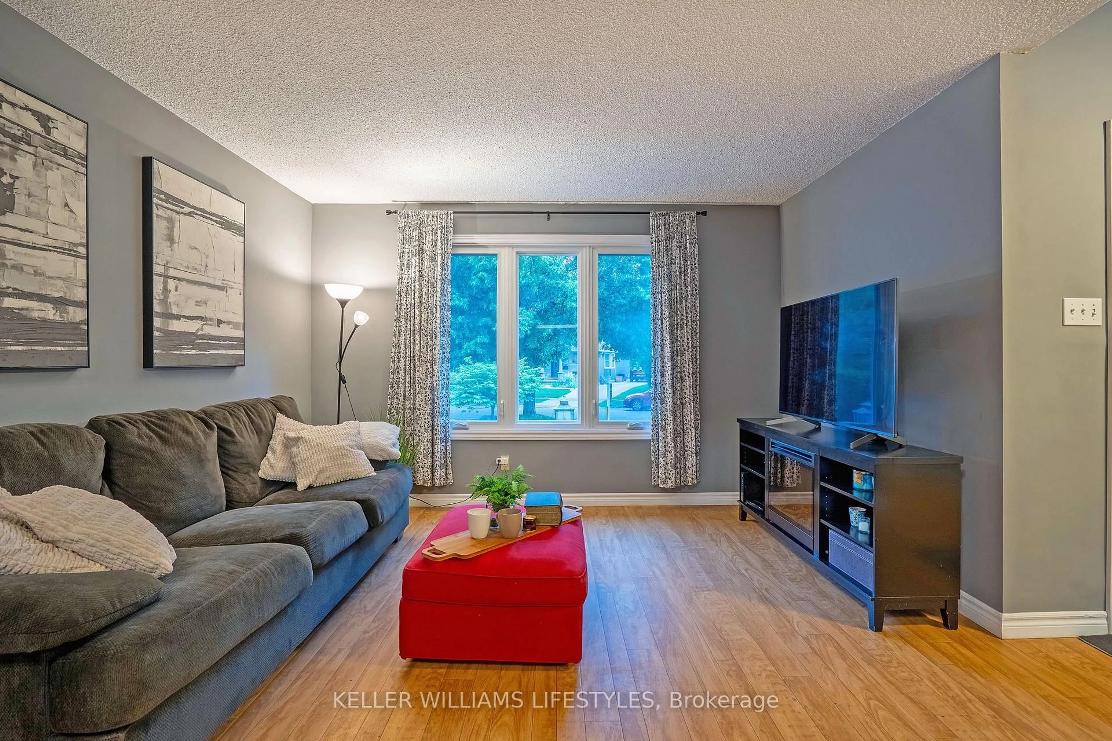 Living room with furniture, wood/laminate floor for 21 Beechbank Cres, London South Ontario N6E 2N9