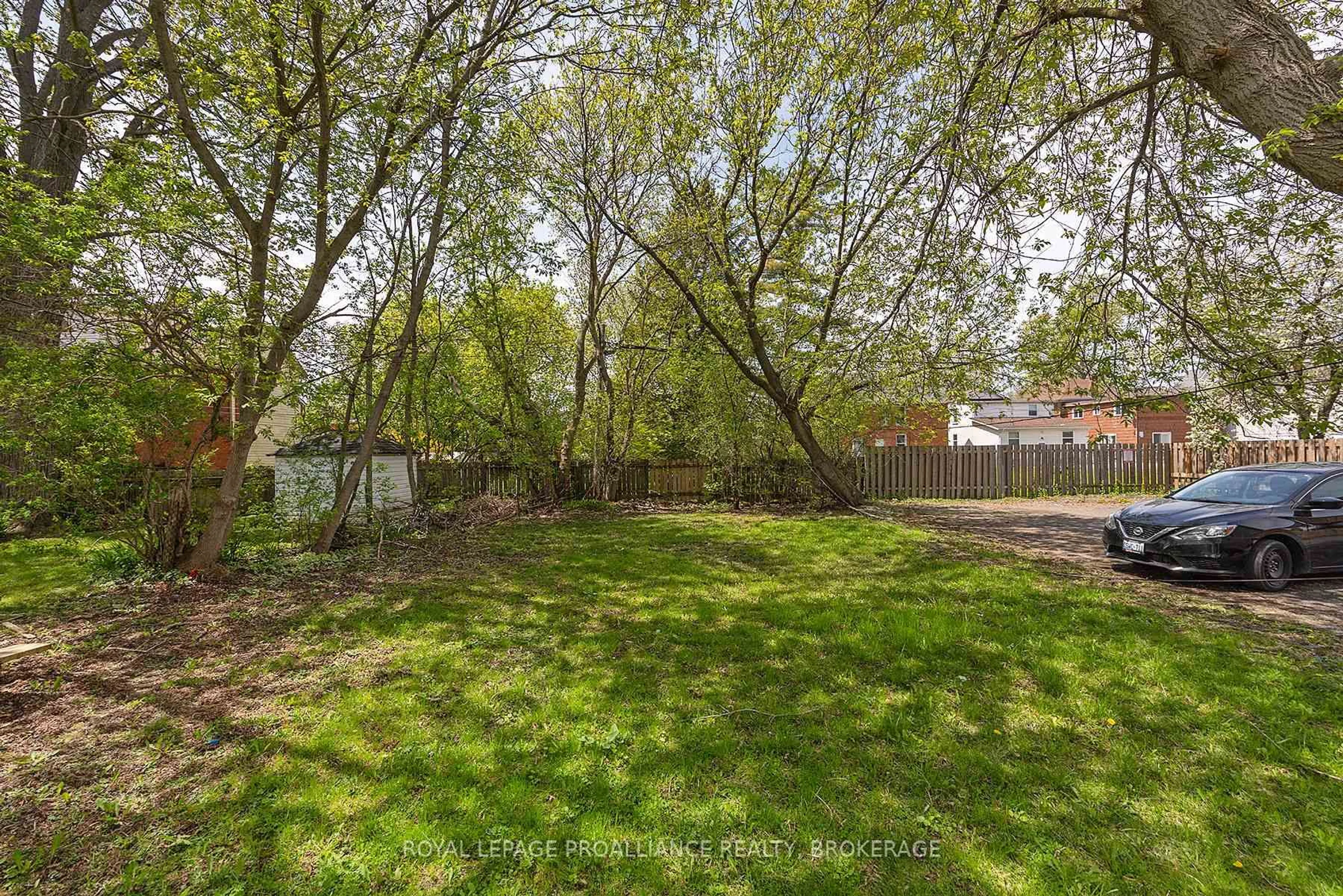 A pic from outside/outdoor area/front of a property/back of a property/a pic from drone, forest/trees view for 210-212 University Ave, Kingston Ontario K7L 3P6