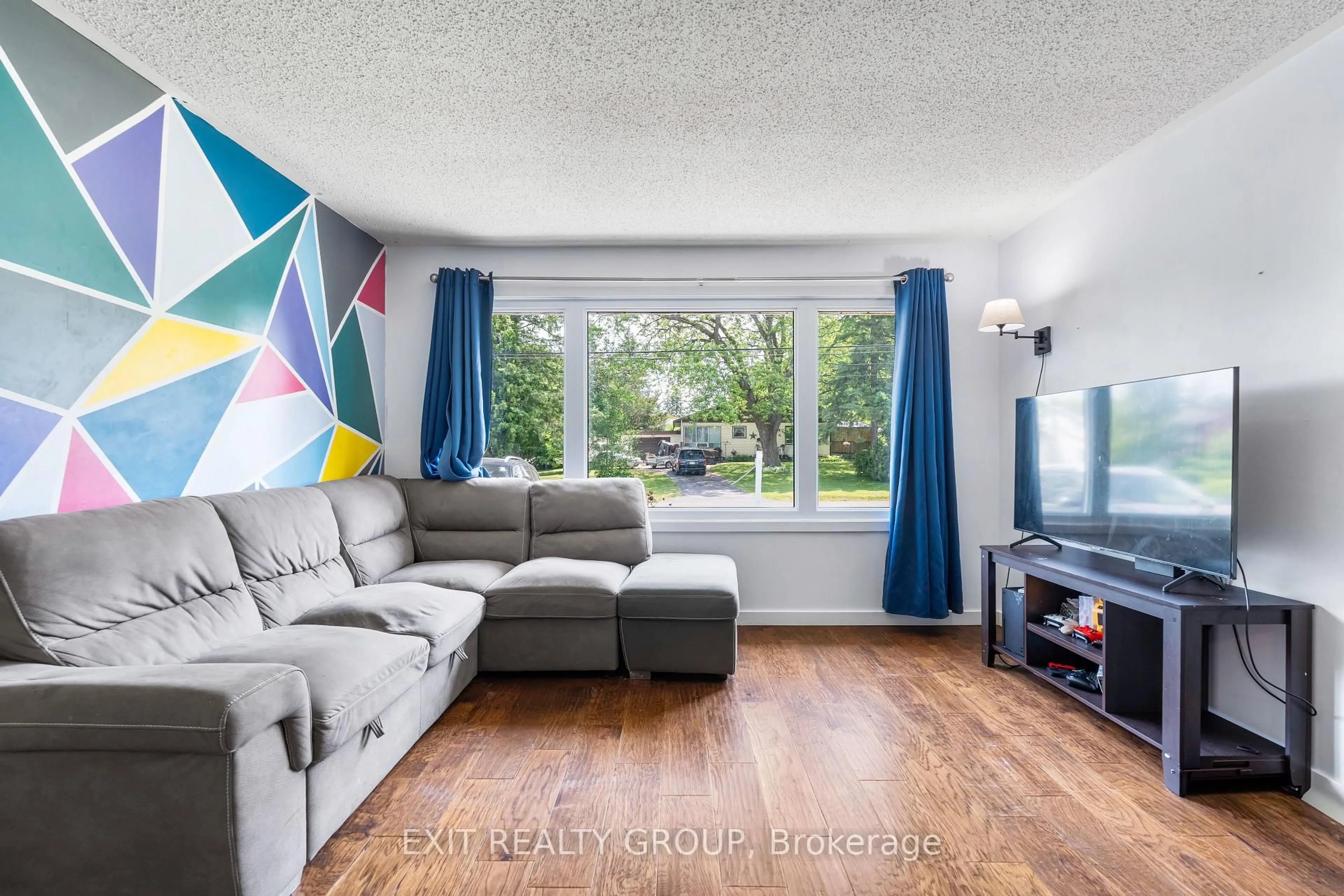 Living room with furniture, wood/laminate floor for 94 Maple Dr, Belleville Ontario K8P 2R2