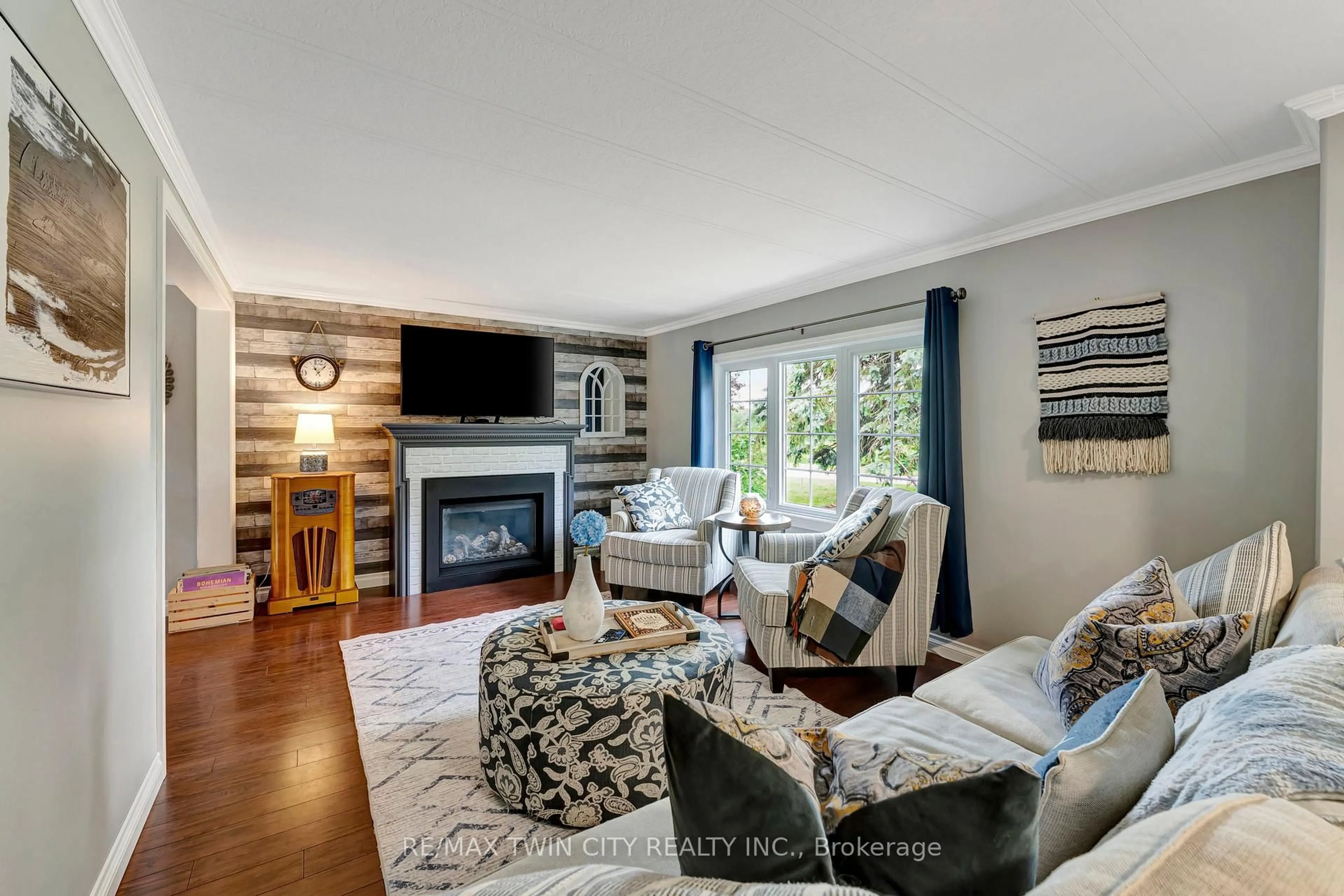 Living room with furniture, wood/laminate floor for 806201 Oxford 29 Rd #67, Blandford-Blenheim Ontario N0J 1M0