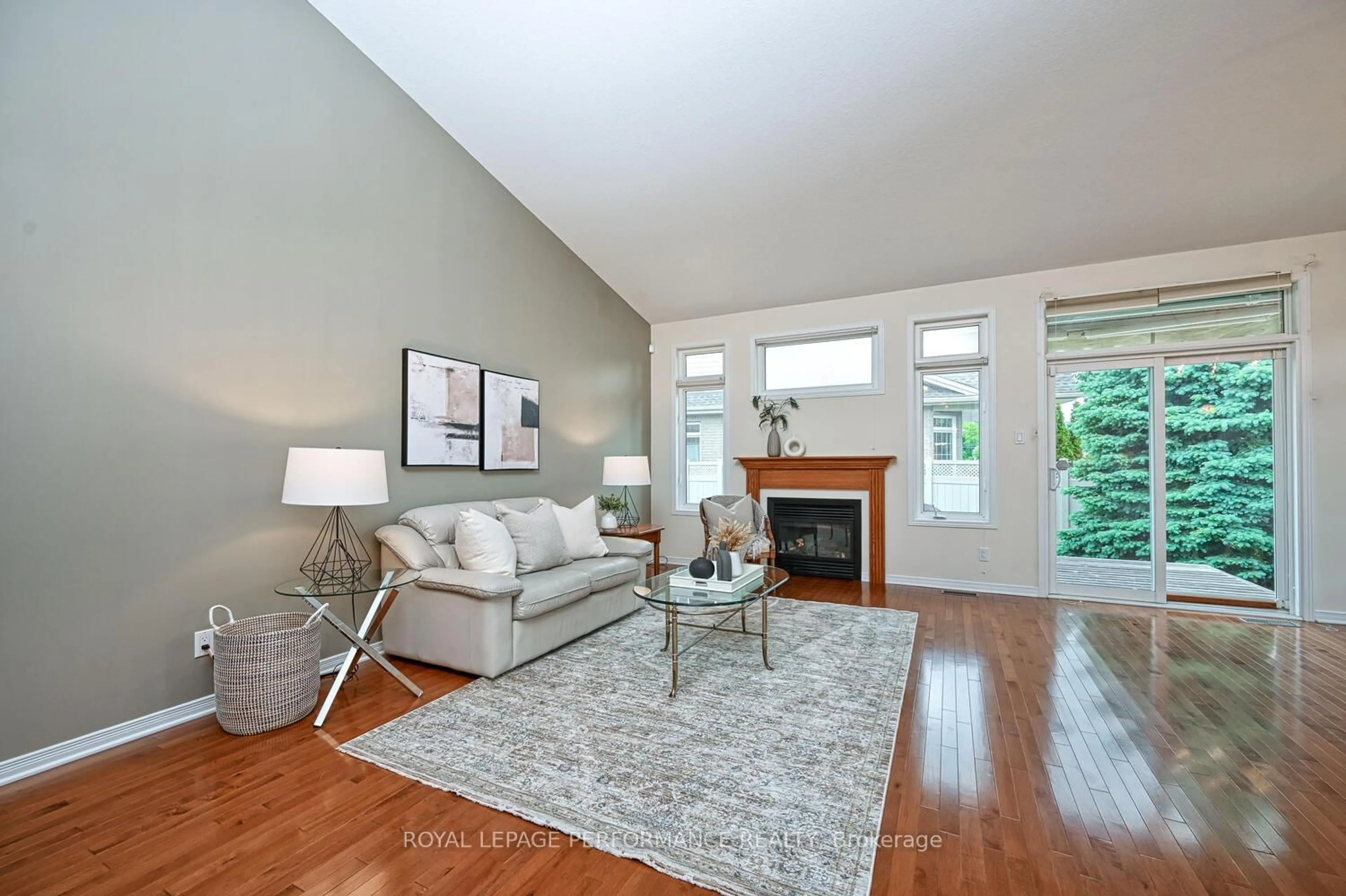 Living room with furniture, wood/laminate floor for 129 Maple Key Private, Ottawa Ontario K1T 0E2
