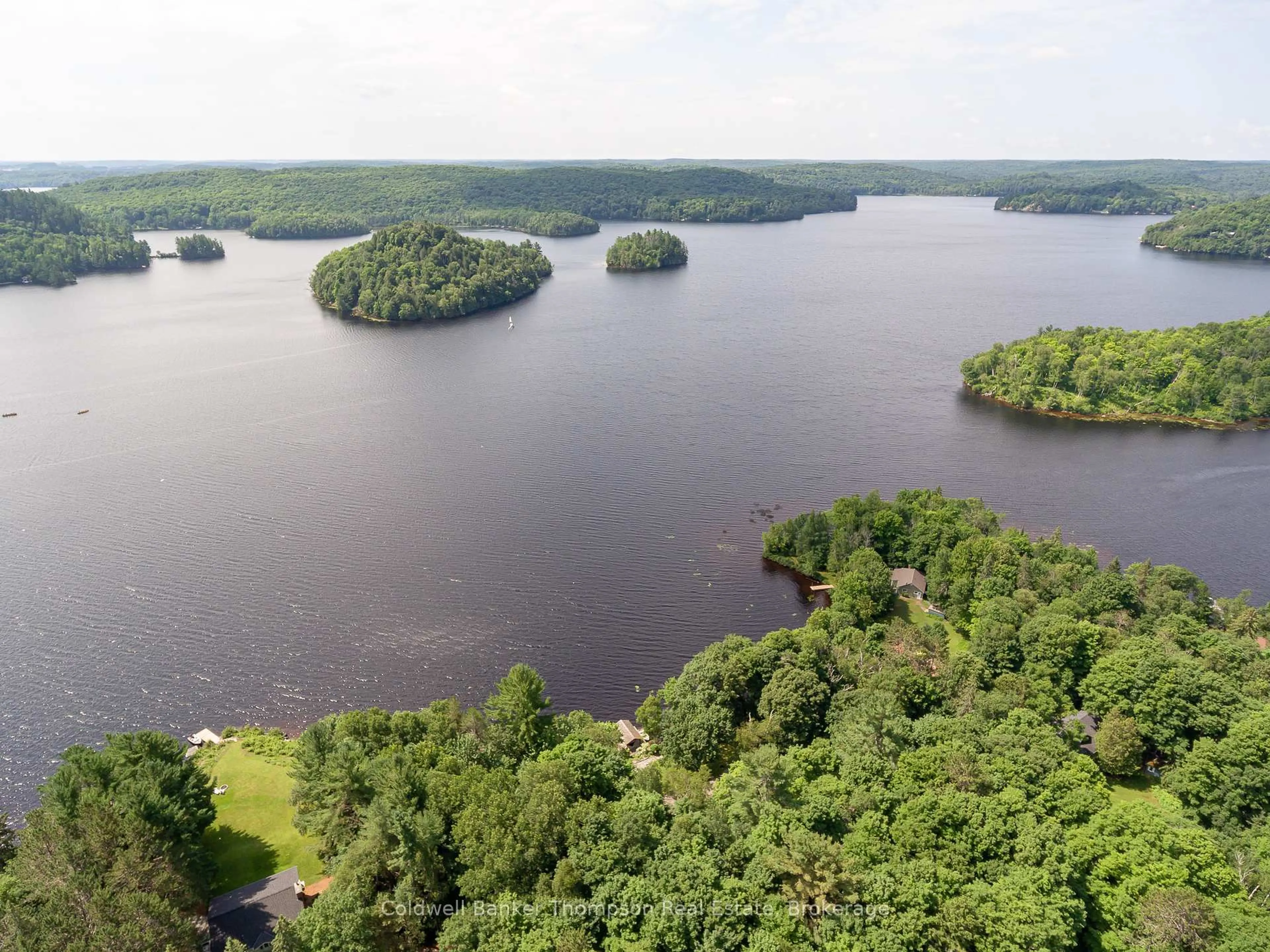 A pic from outside/outdoor area/front of a property/back of a property/a pic from drone, water/lake/river/ocean view for 54 Rowan Dr, Huntsville Ontario P1H 2J2