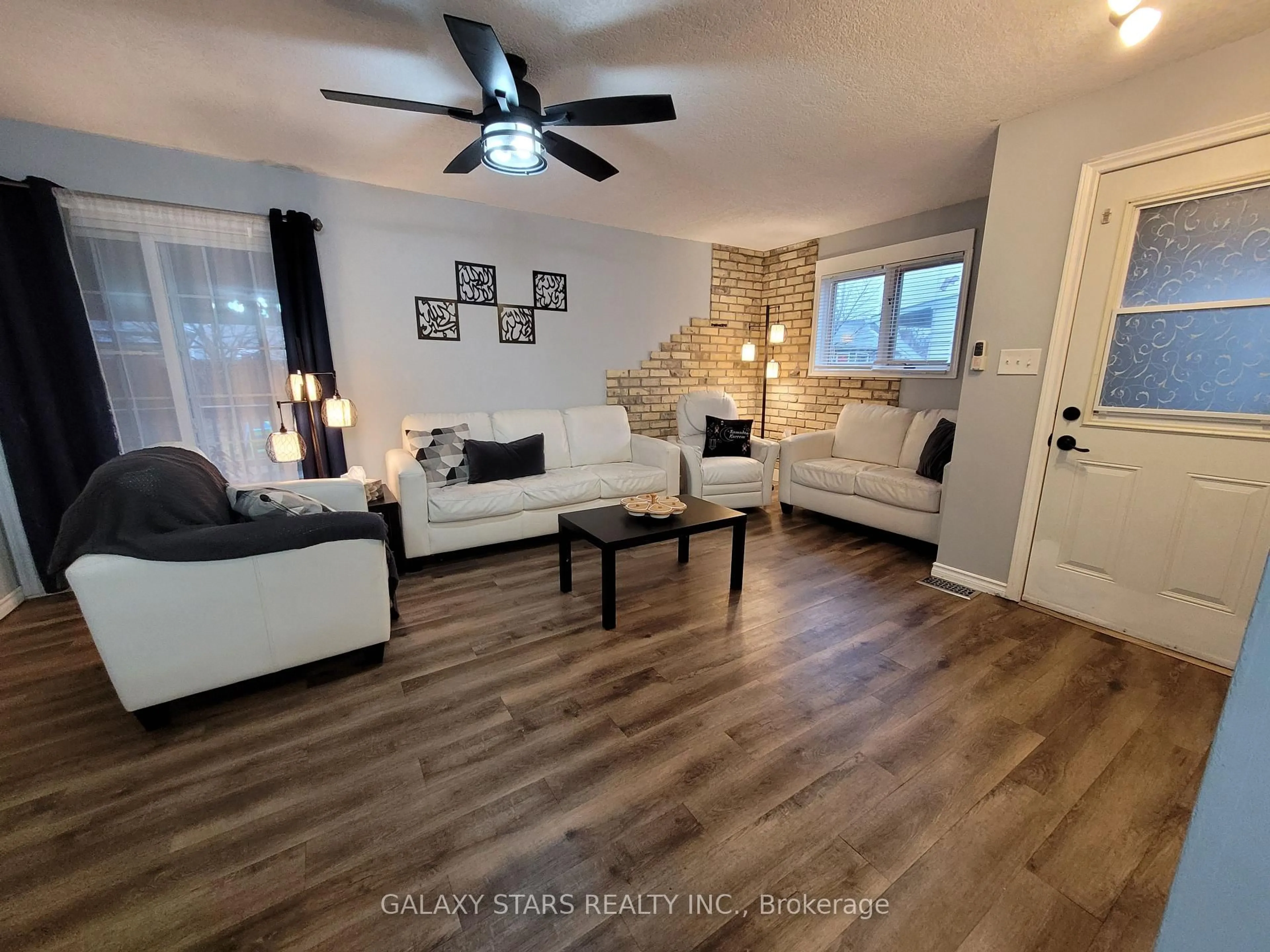 Living room with furniture, wood/laminate floor for 49 Seventh Ave, Brantford Ontario N3S 1B3