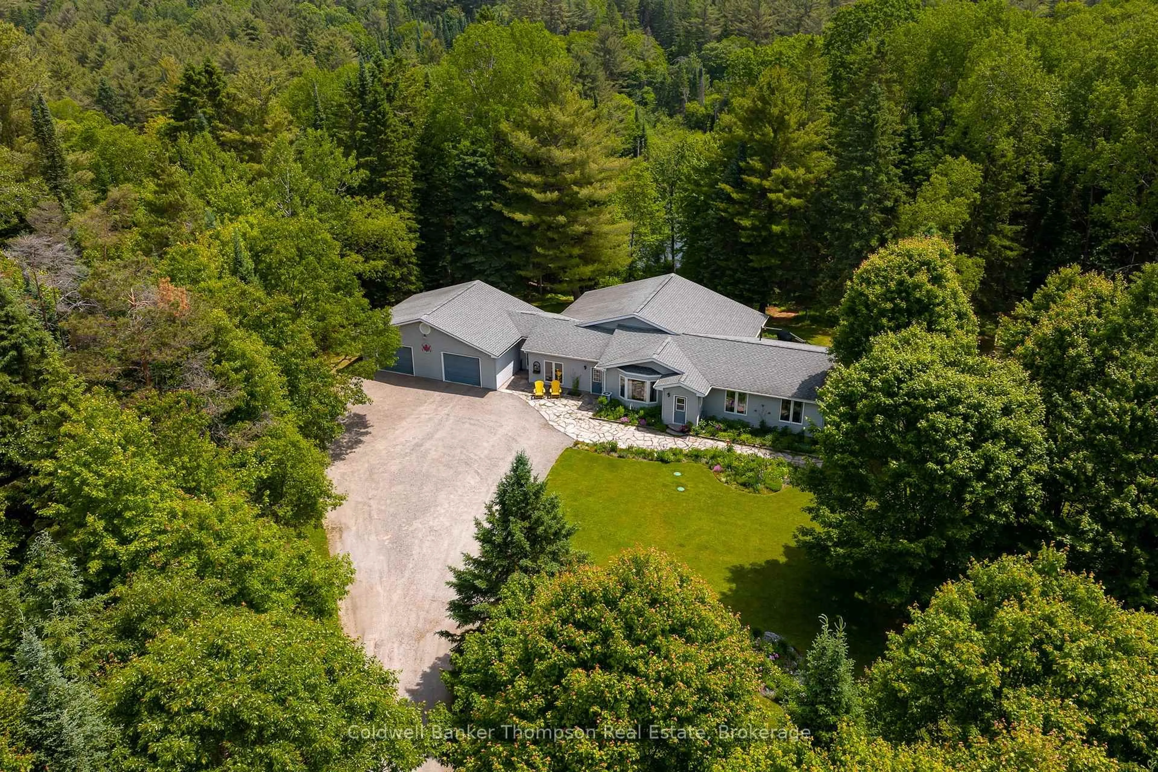 A pic from outside/outdoor area/front of a property/back of a property/a pic from drone, forest/trees view for 57 Hiawatha Dr, Huntsville Ontario P0B 1L0