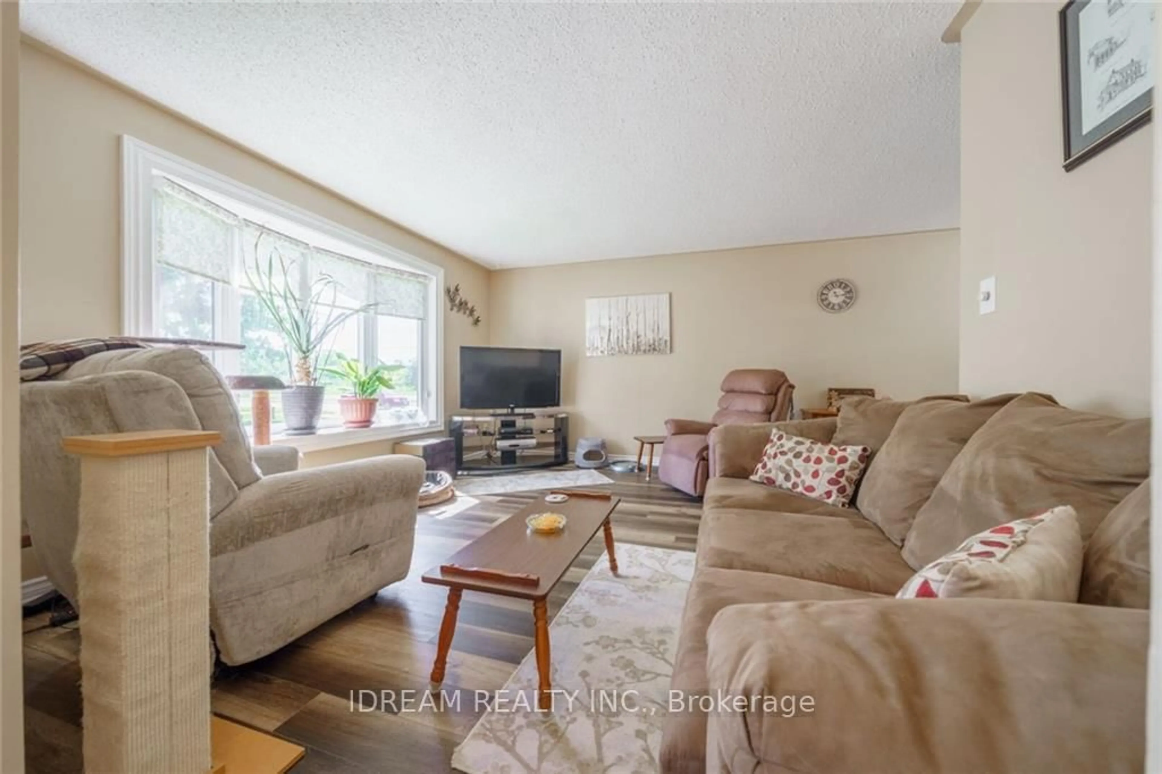 Living room with furniture, wood/laminate floor for 310 Brant St, Haldimand Ontario N1A 2A8