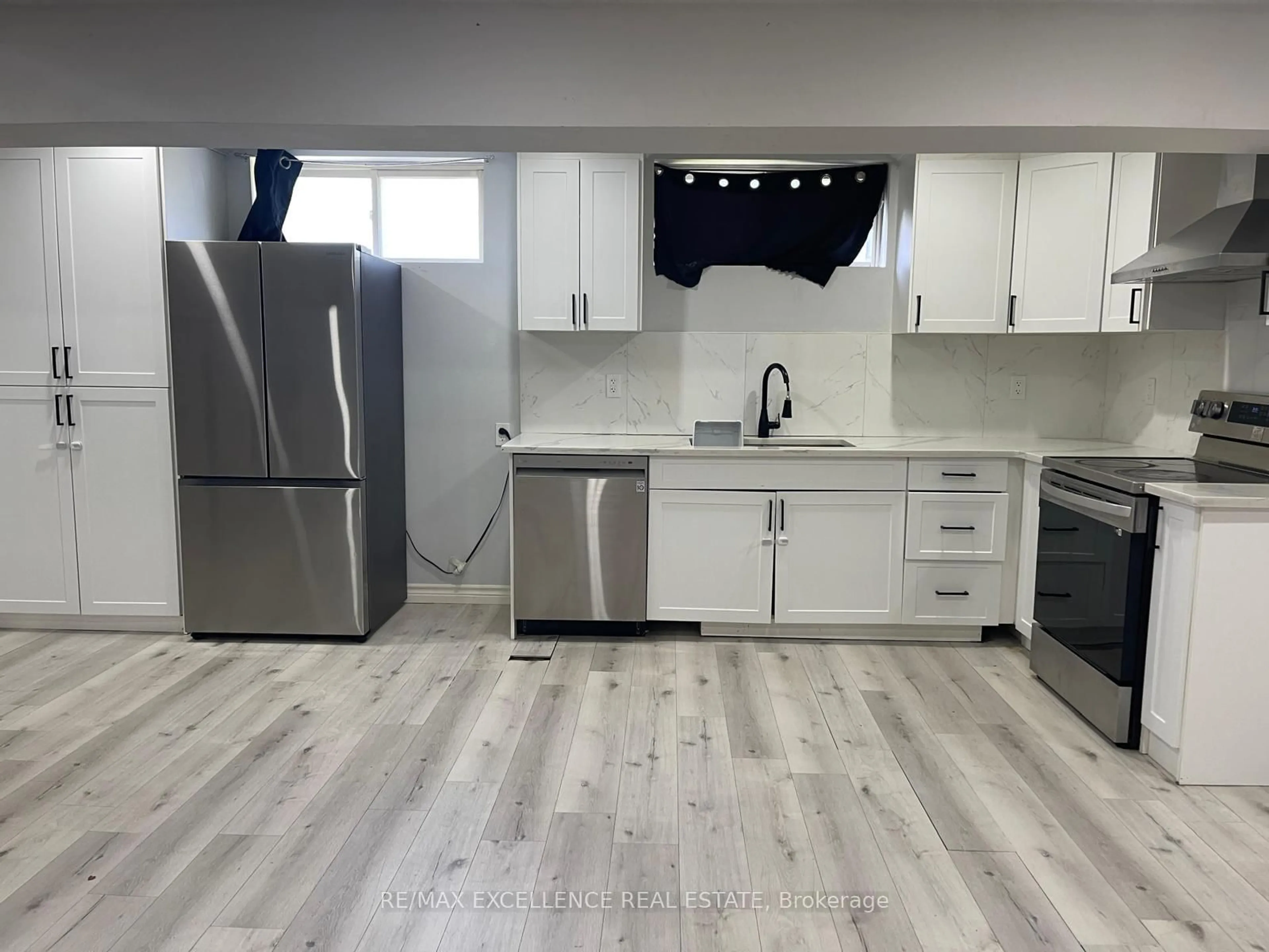 Open concept kitchen, wood/laminate floor for 1595 BORDEN St, London East Ontario N5W 2P9