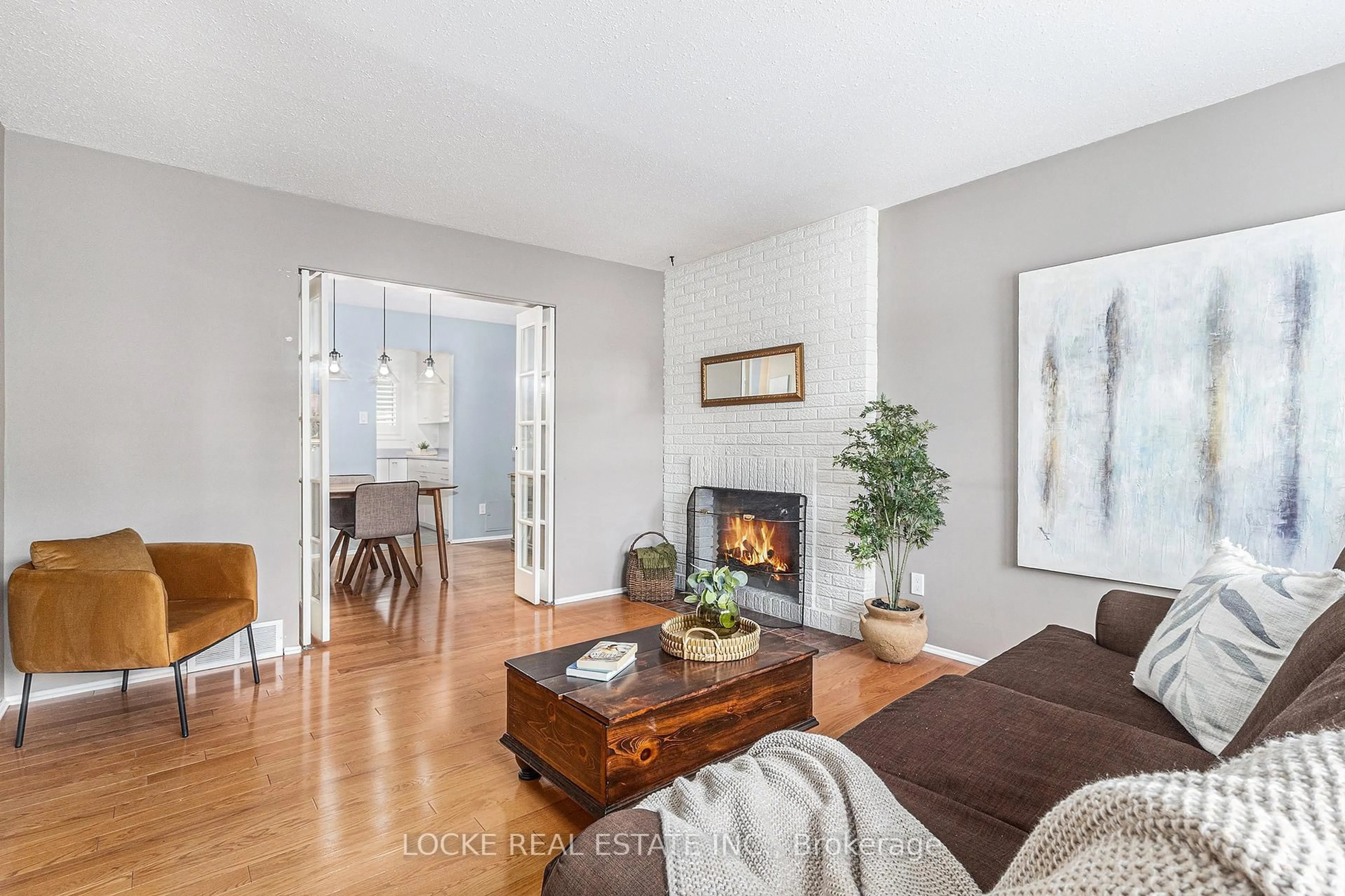 Living room with furniture, wood/laminate floor for 2111 Montreal Rd #101, Ottawa Ontario K1J 8M8