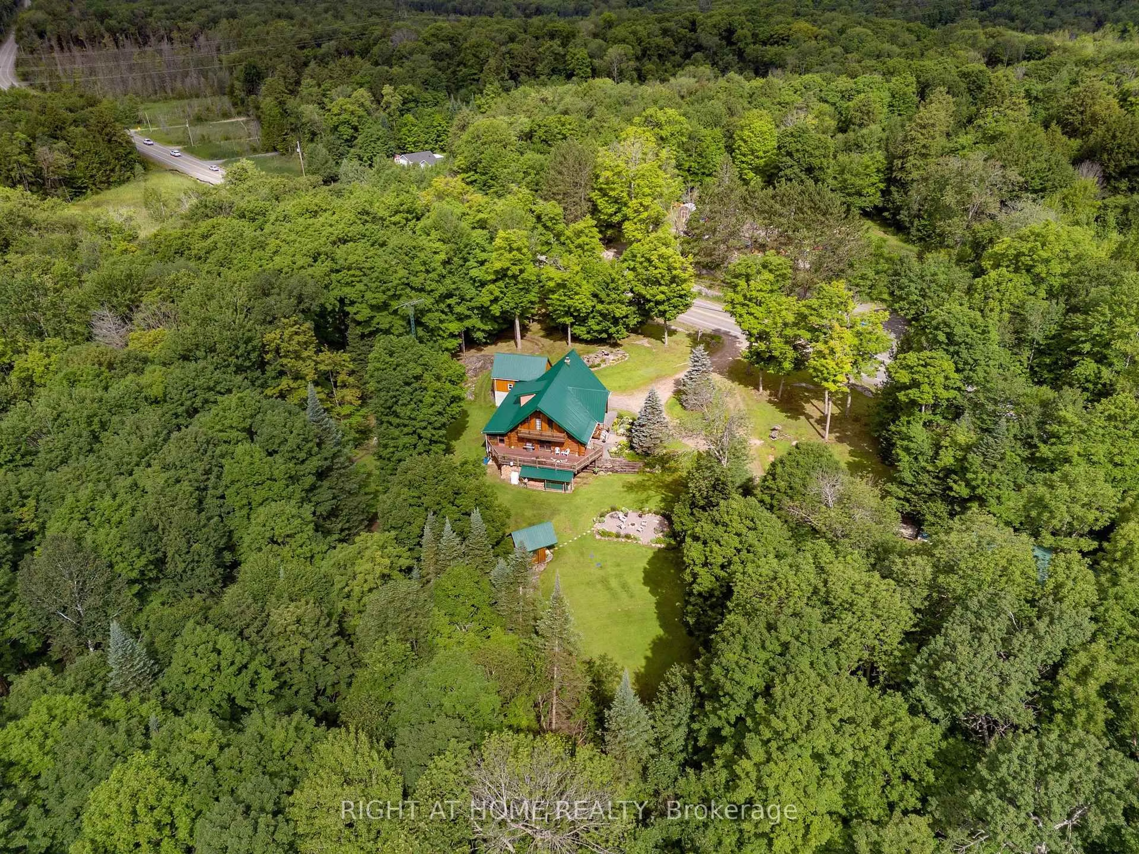 A pic from outside/outdoor area/front of a property/back of a property/a pic from drone, forest/trees view for 1696 Highway 118, Bracebridge Ontario P1L 1X1