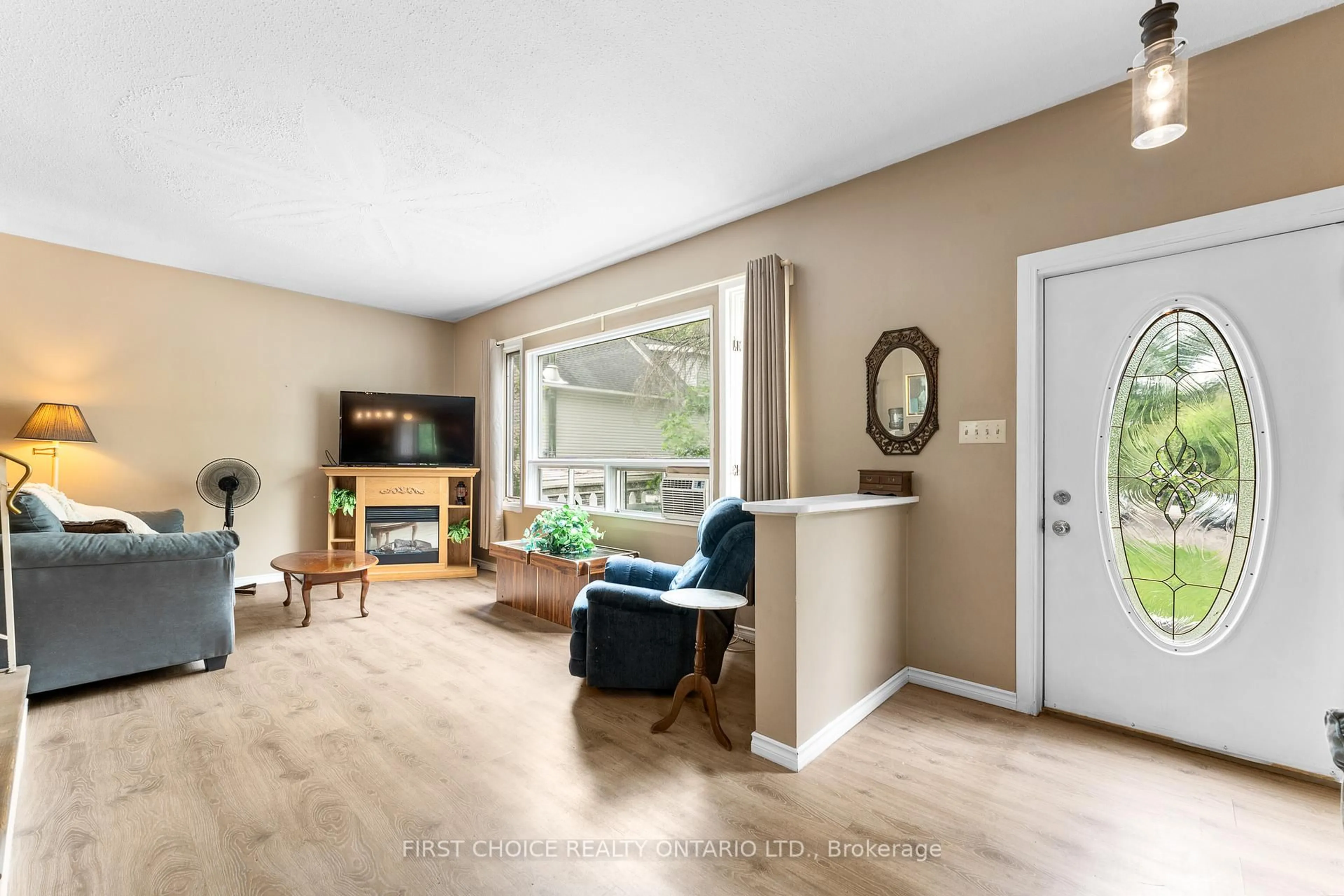 Living room with furniture, wood/laminate floor for 96 Constance Lake Rd, Ottawa Ontario K2K 1X7