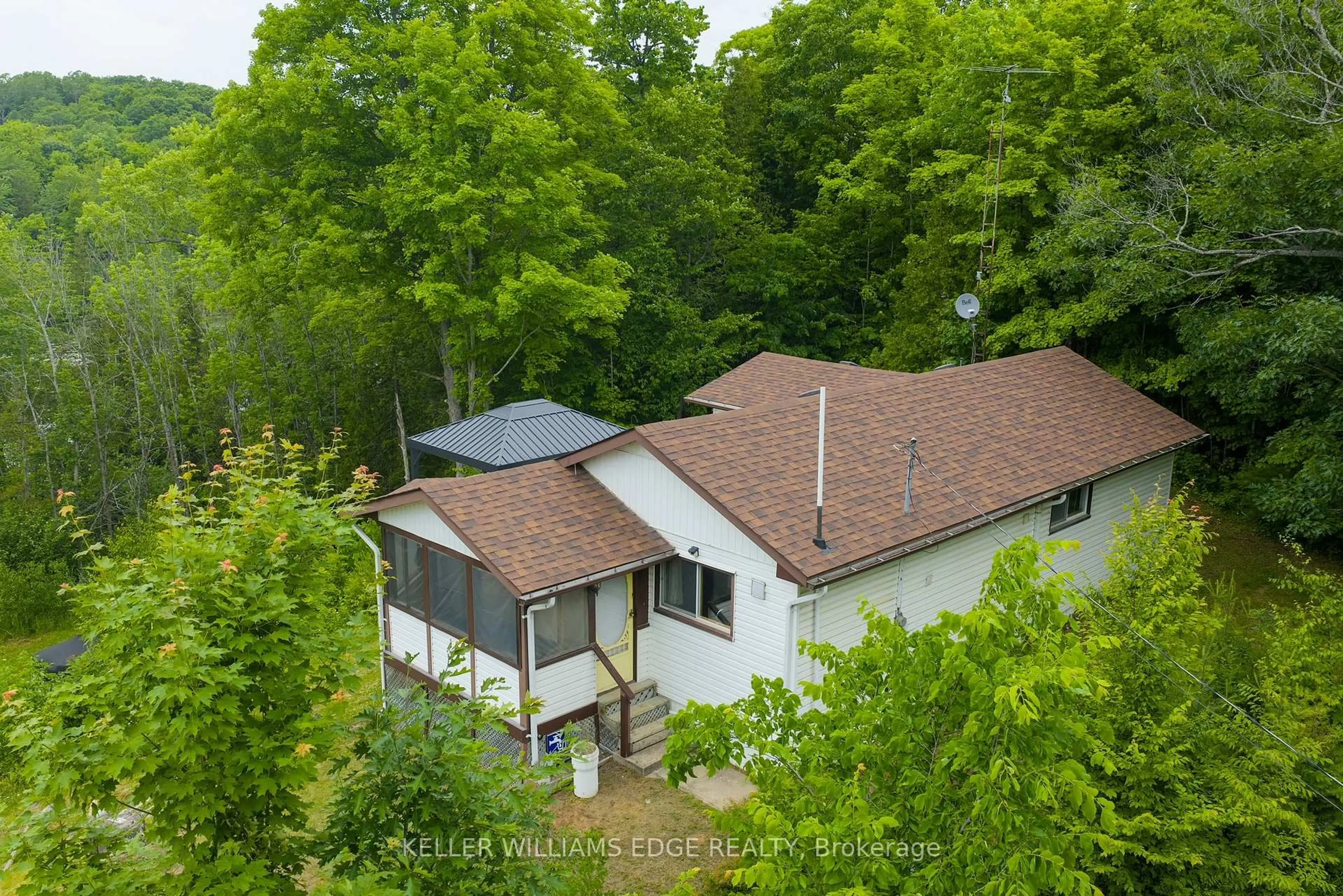 A pic from outside/outdoor area/front of a property/back of a property/a pic from drone, forest/trees view for 1180 Guigue Rd, Sharbot Lake Ontario K0H 2P0