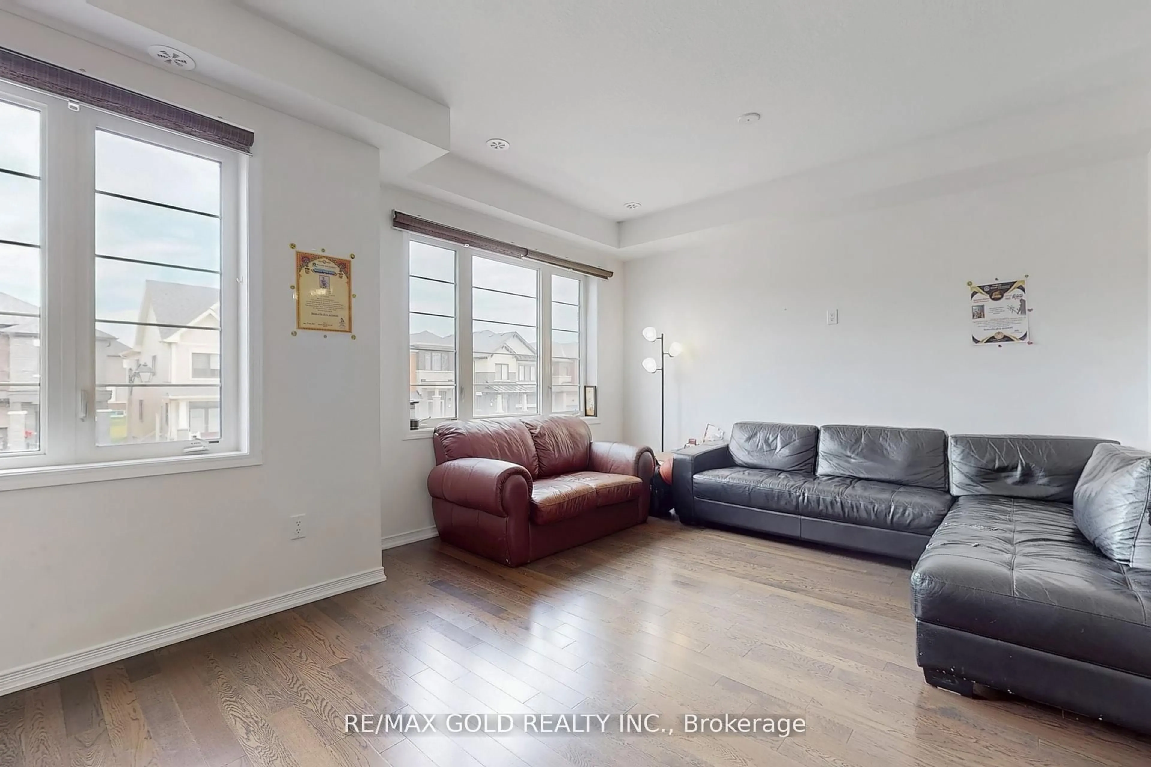 Living room with furniture, wood/laminate floor for 65 Holder Dr, Brantford Ontario N3T 0W8