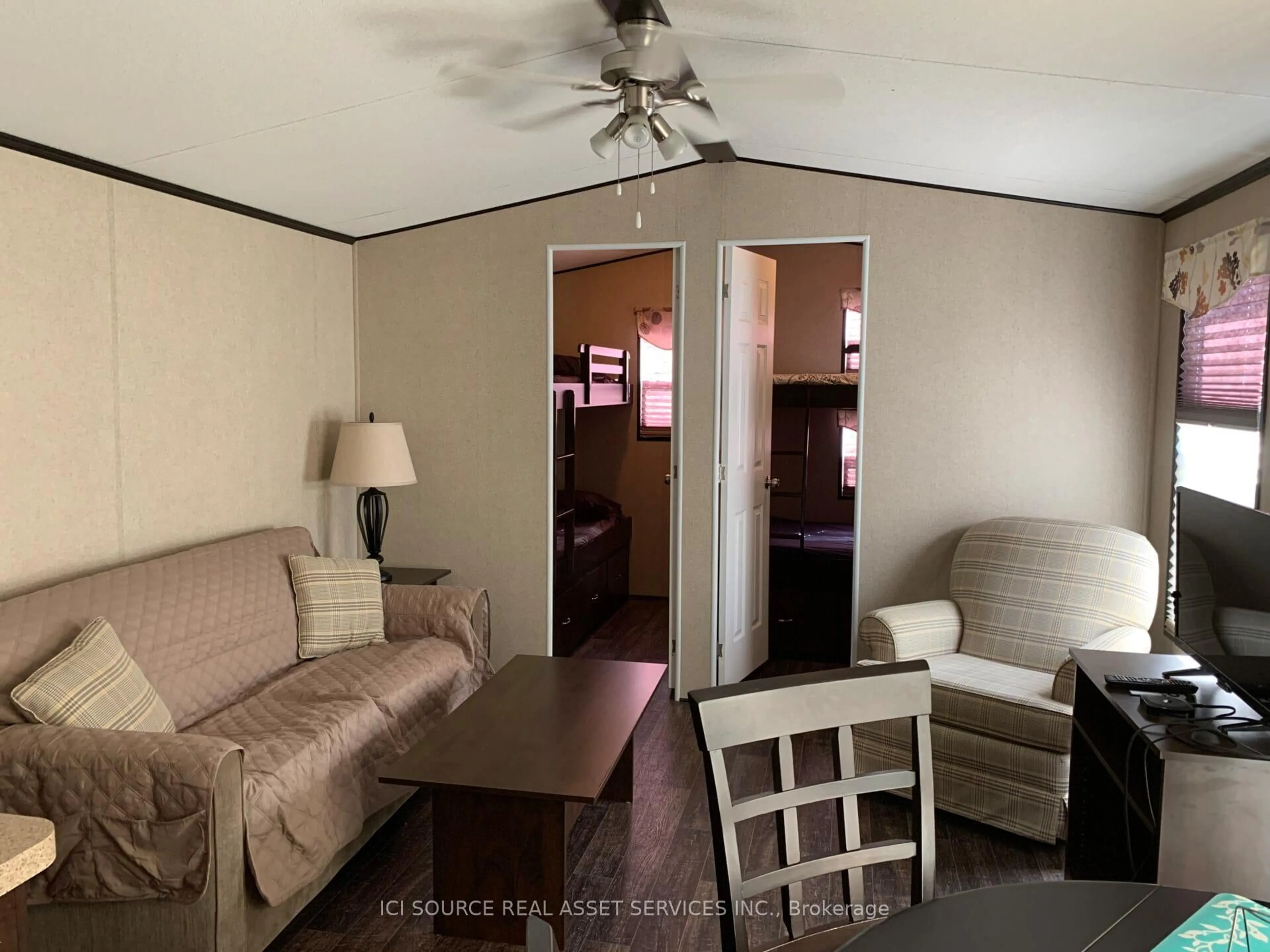 Living room with furniture, wood/laminate floor for 1082 Shamrock Marina Rd #SMR056, Gravenhurst Ontario P0E 1N0