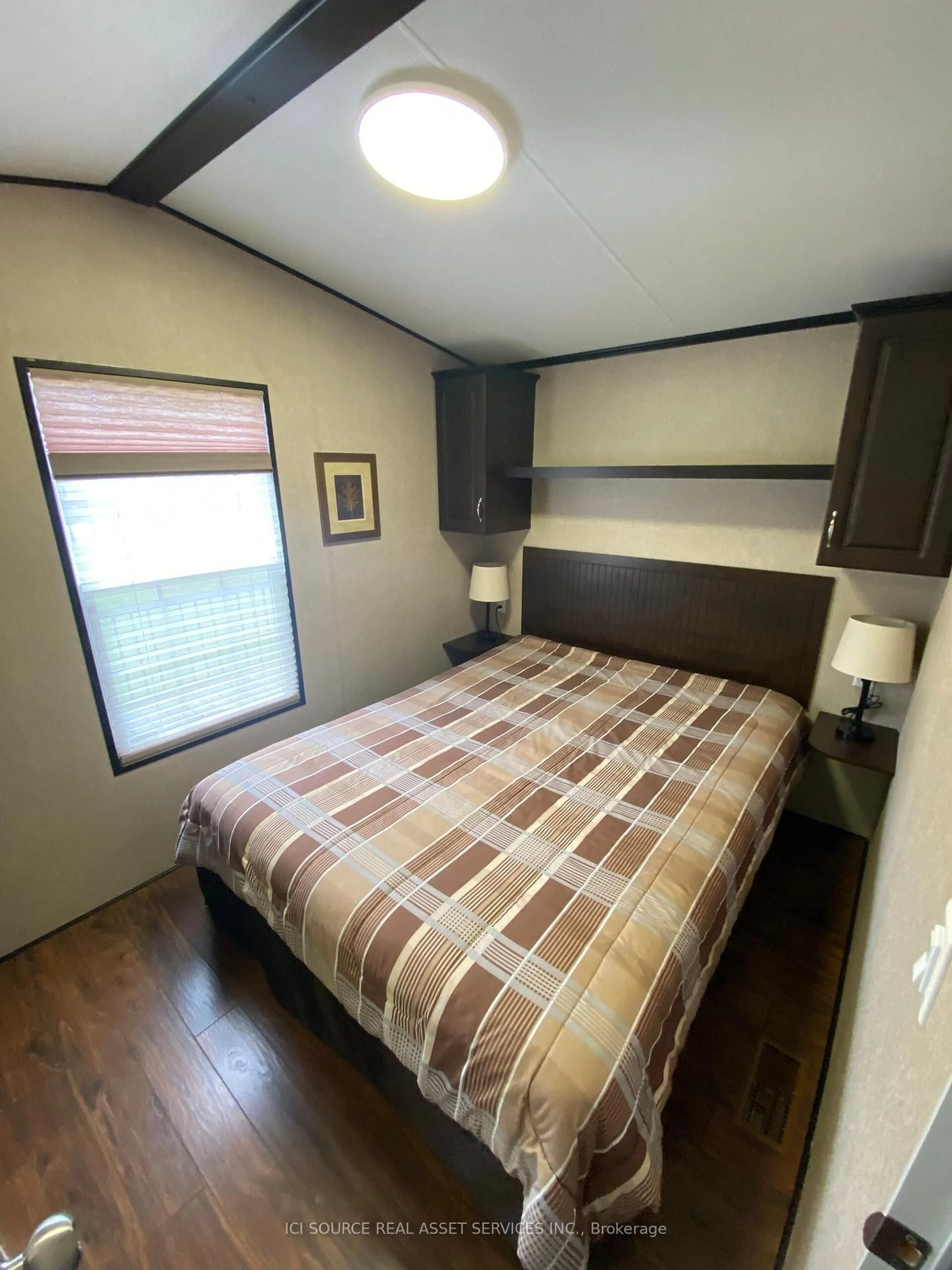 Bedroom with bed, wood/laminate floor for 1082 Shamrock Marina Rd #SMR089, Gravenhurst Ontario P0E 1N0