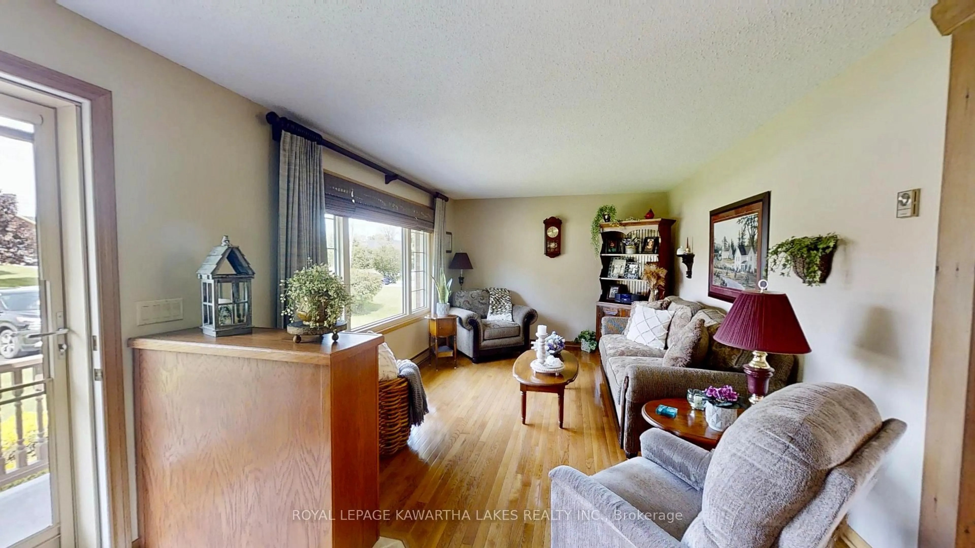 Living room with furniture, wood/laminate floor for 30 Grant Dr, Kawartha Lakes Ontario K0M 2M0