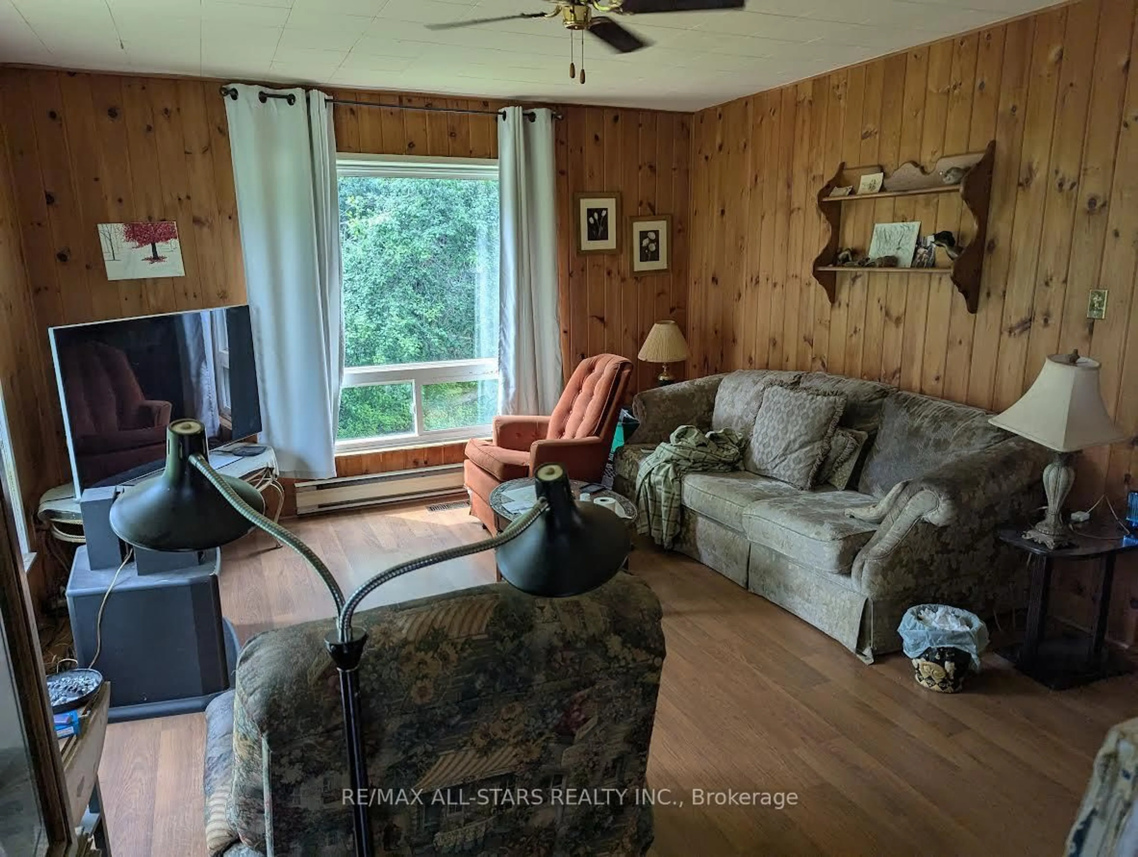 Living room with furniture, wood/laminate floor for 234 Crosby Dr, Kawartha Lakes Ontario K0M 1A0
