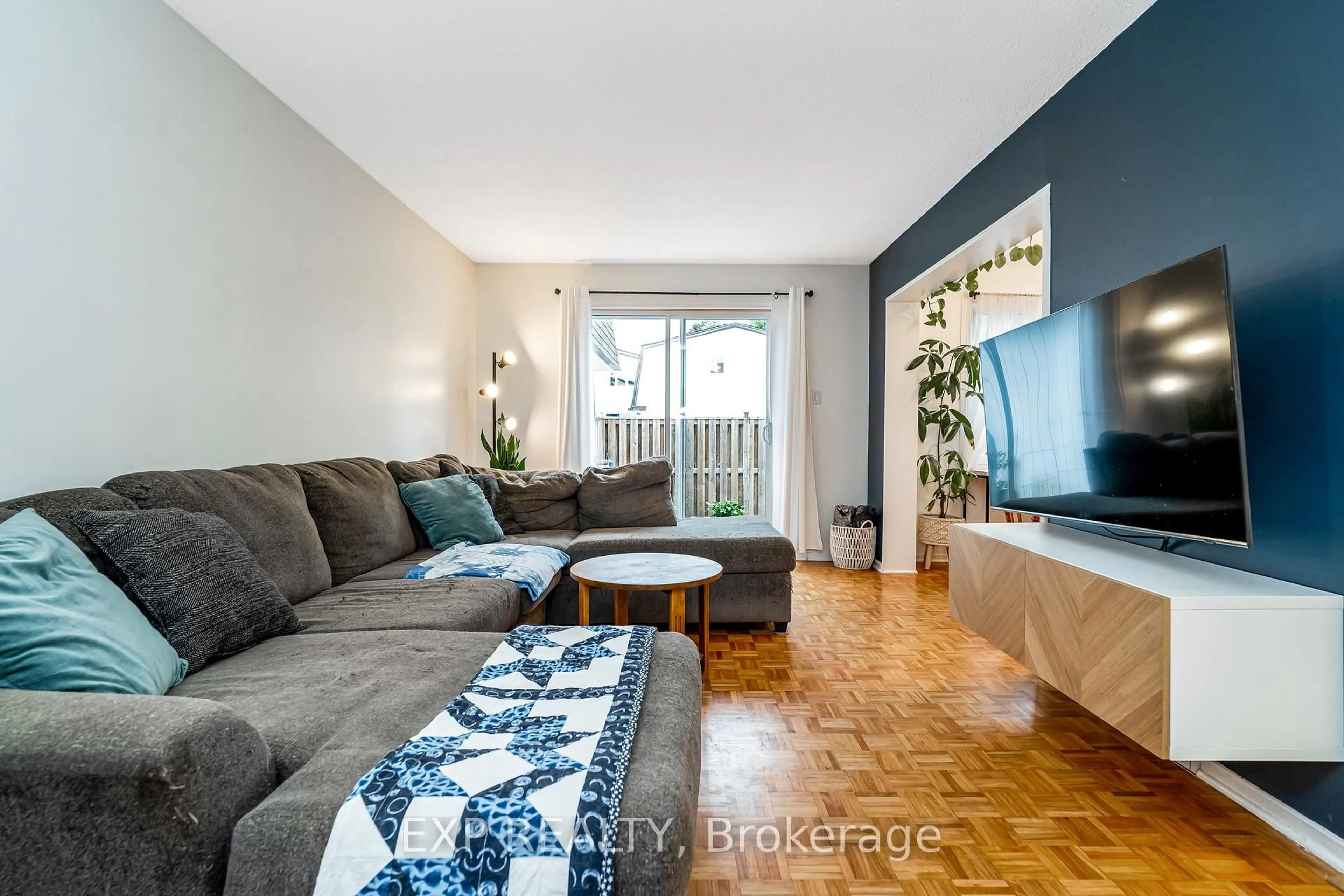 Living room with furniture, wood/laminate floor for 837 Eastvale Dr #78, Ottawa Ontario K1J 7T5