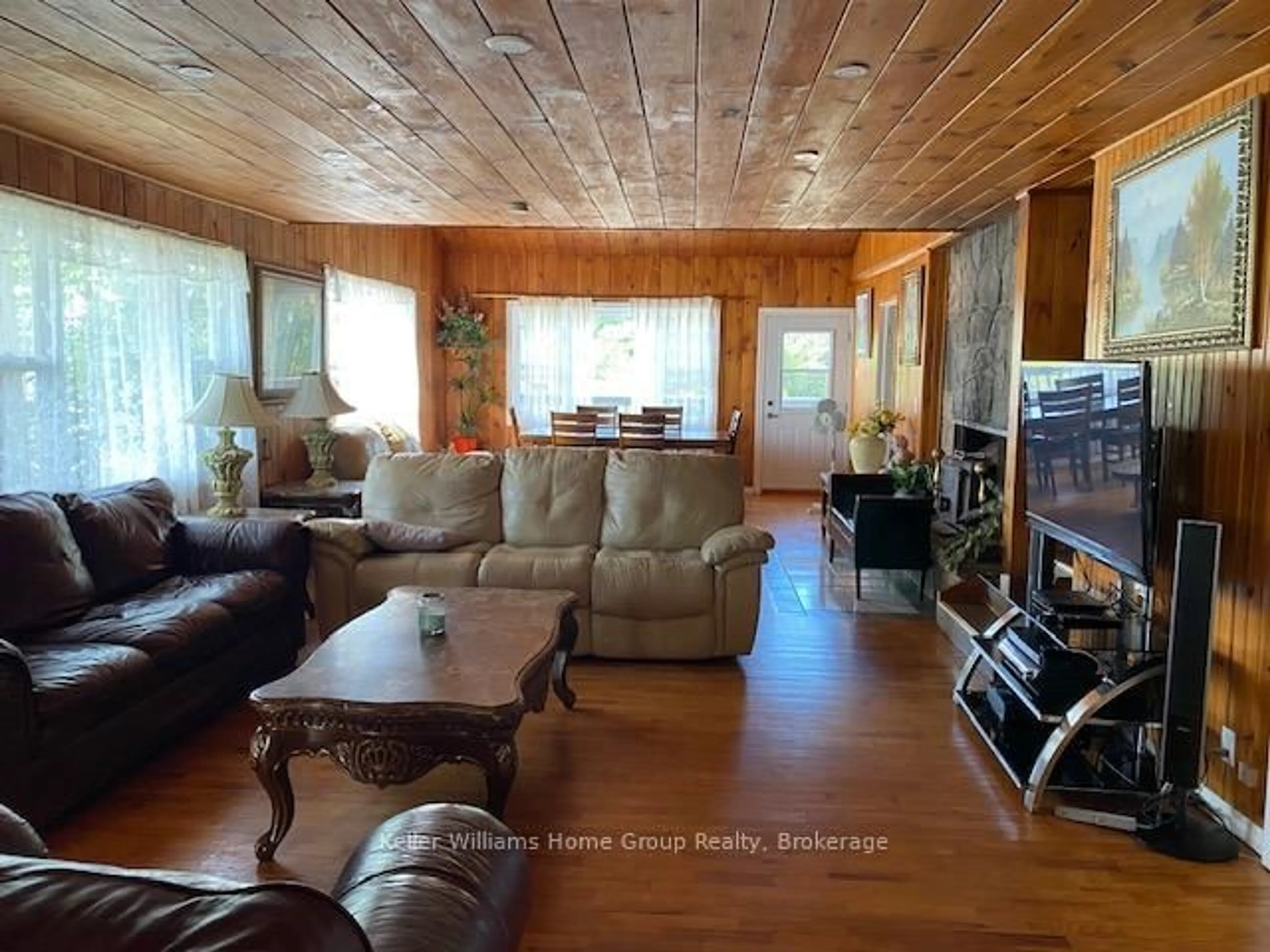 Living room with furniture, wood/laminate floor for 682 Long Lake Rd, Whitney Ontario K0J 2M0