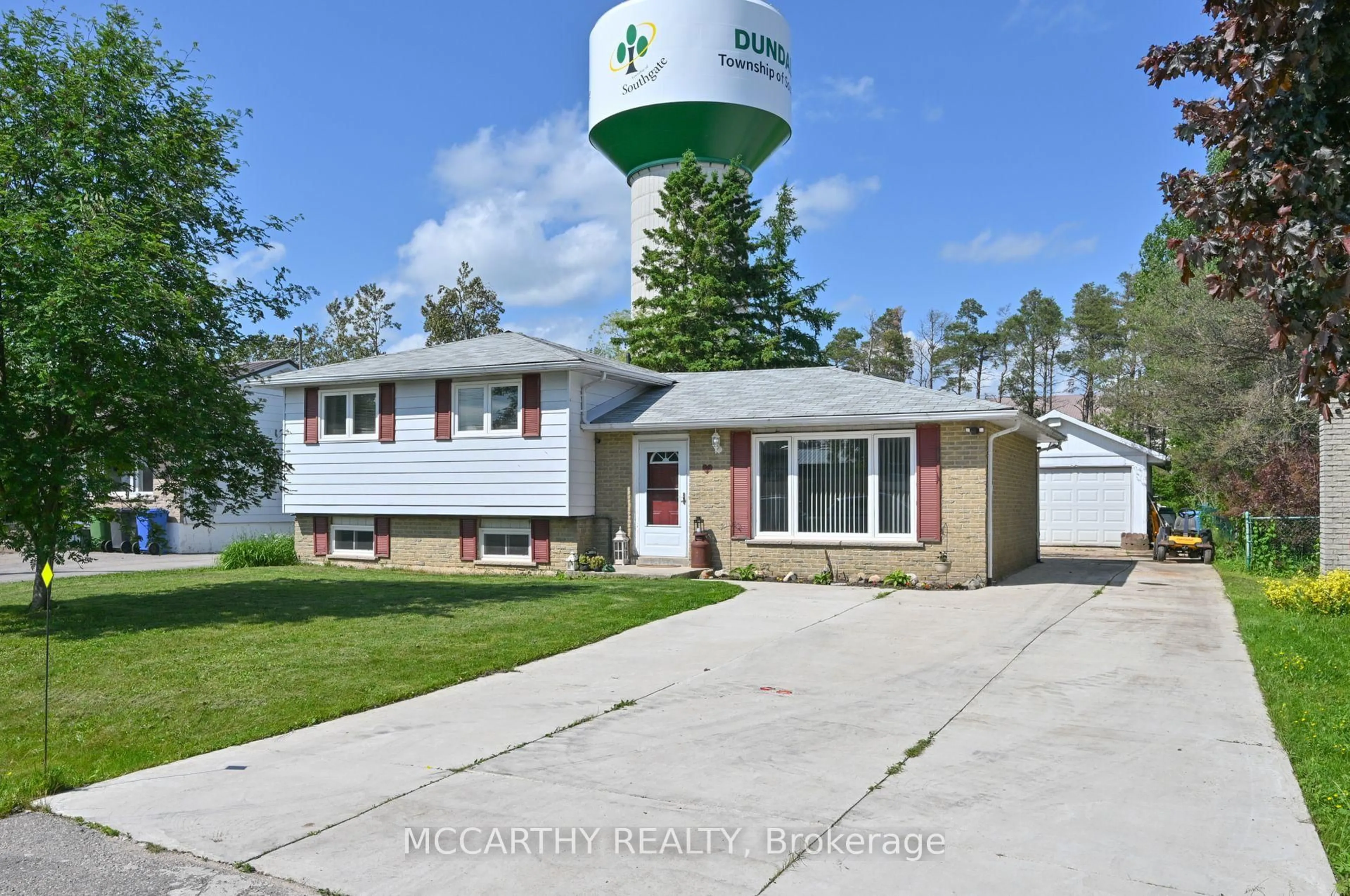 Home with vinyl exterior material, street for 7 McDowell St, Southgate Ontario N0C 1B0