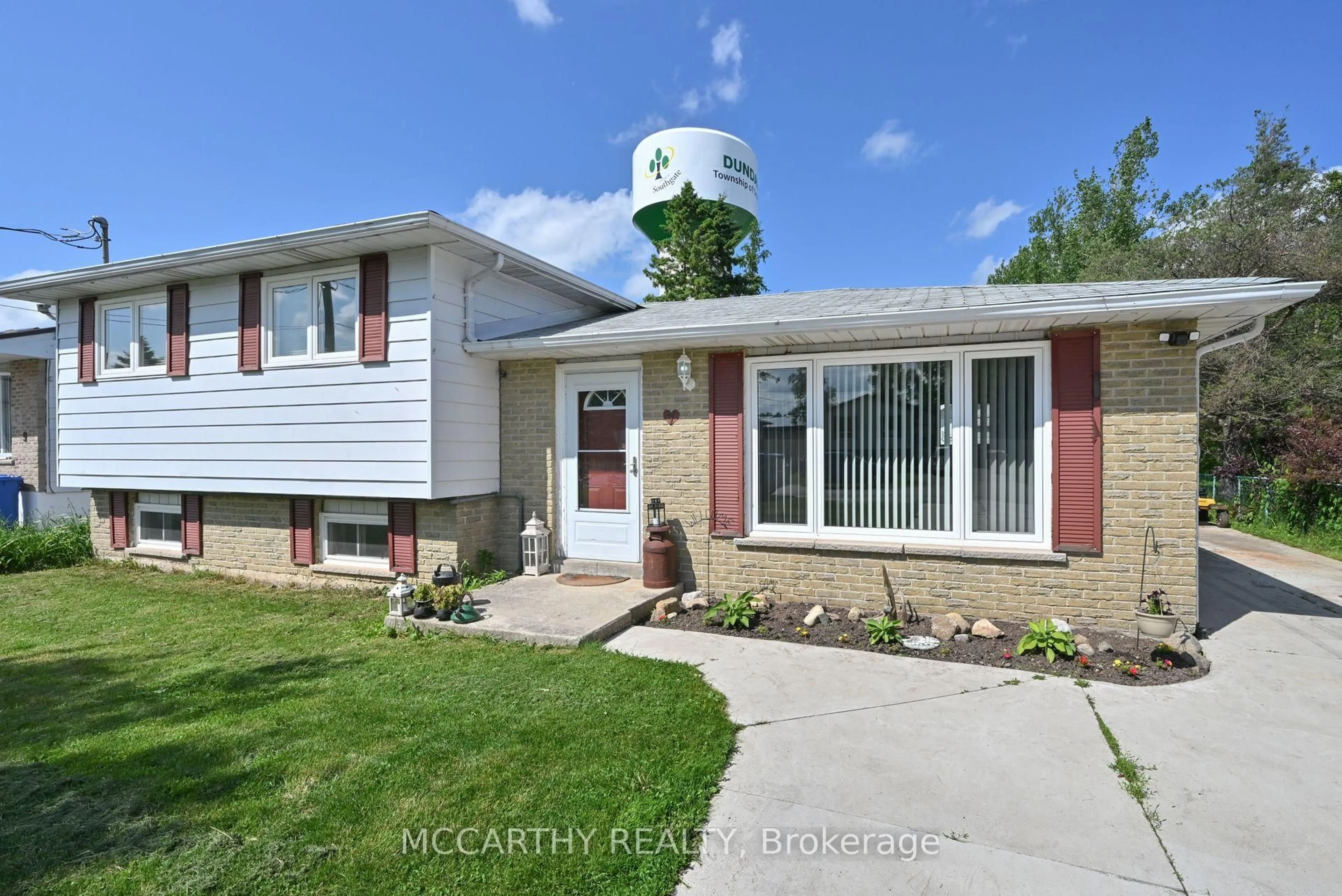 Home with vinyl exterior material, street for 7 McDowell St, Southgate Ontario N0C 1B0