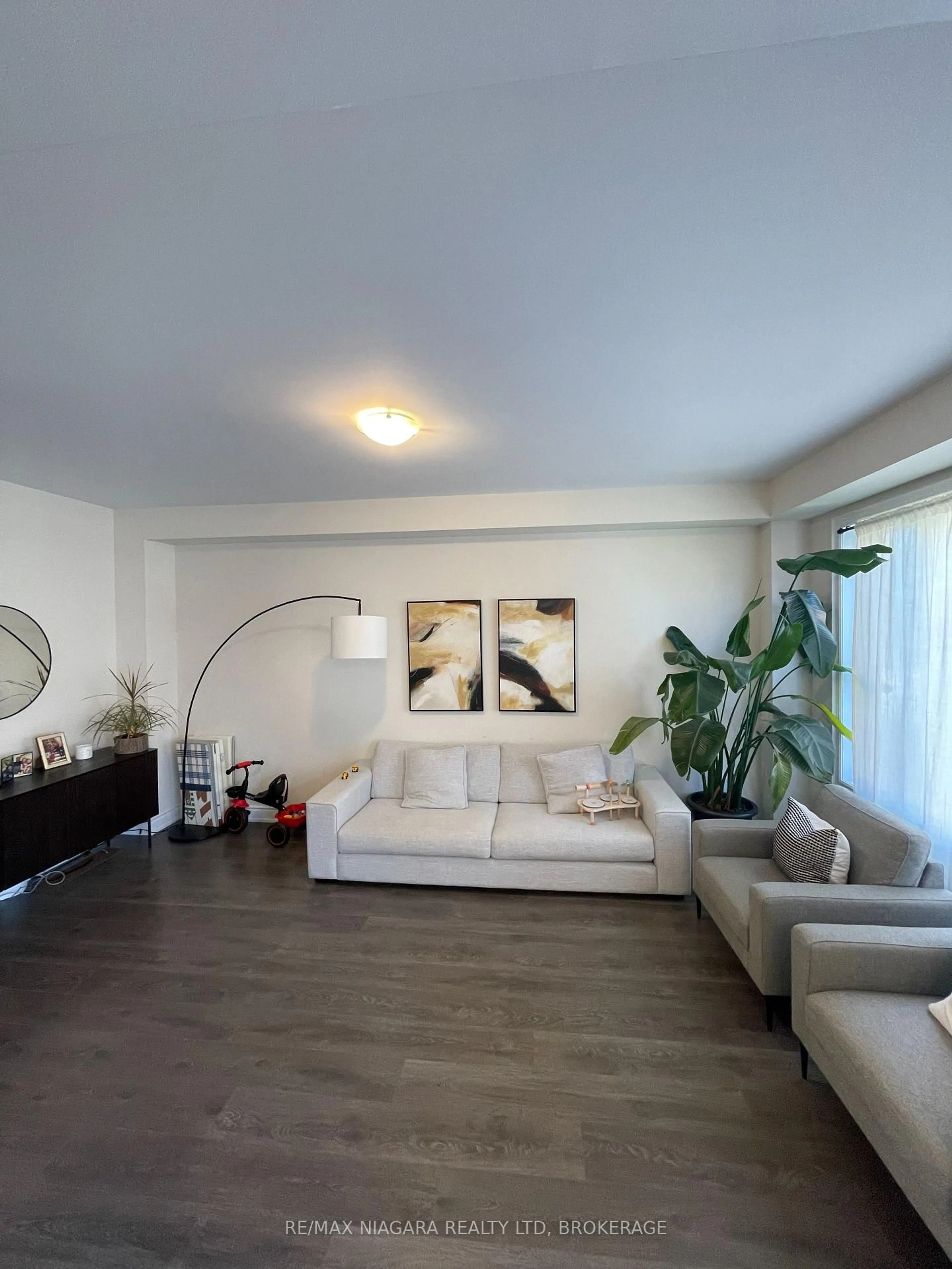 Living room with furniture, wood/laminate floor for 19 Legacy Lane, Thorold Ontario L3B 0G7