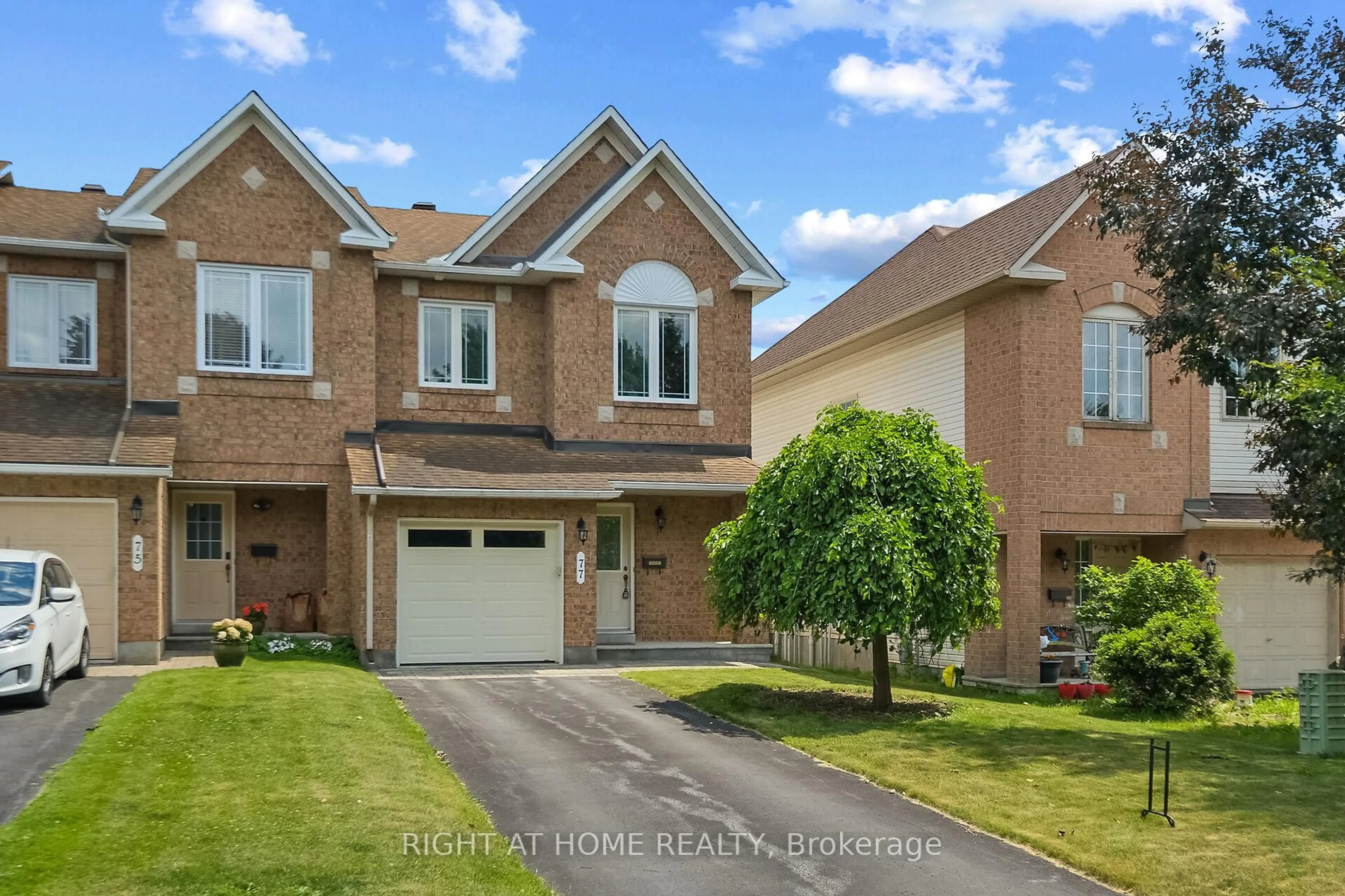 Home with brick exterior material, street for 77 Flowertree Cres, Ottawa Ontario K2M 2R7