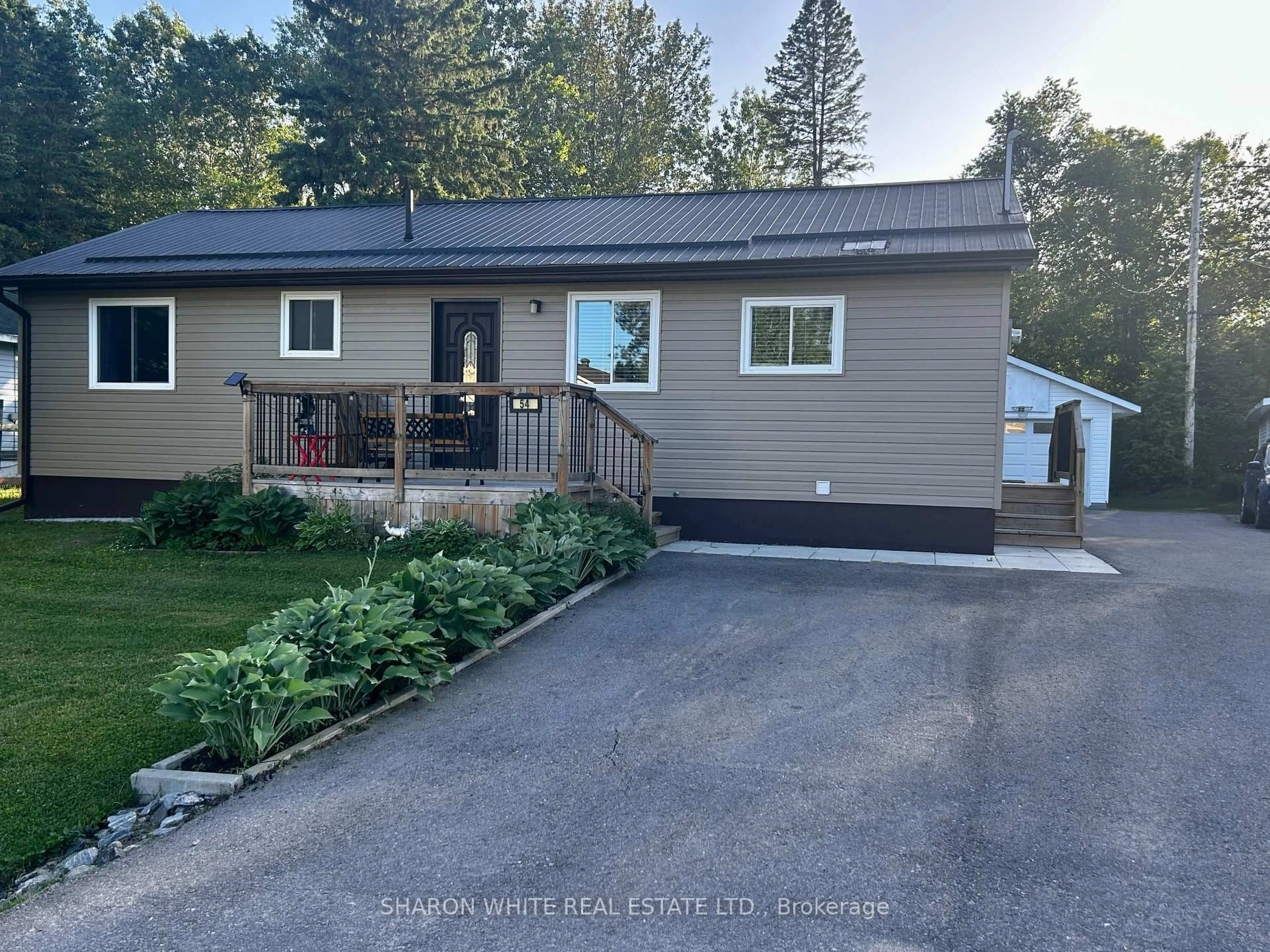 Home with vinyl exterior material, street for 54 Sprucedale St St, Highlands East Ontario K0L 1M0