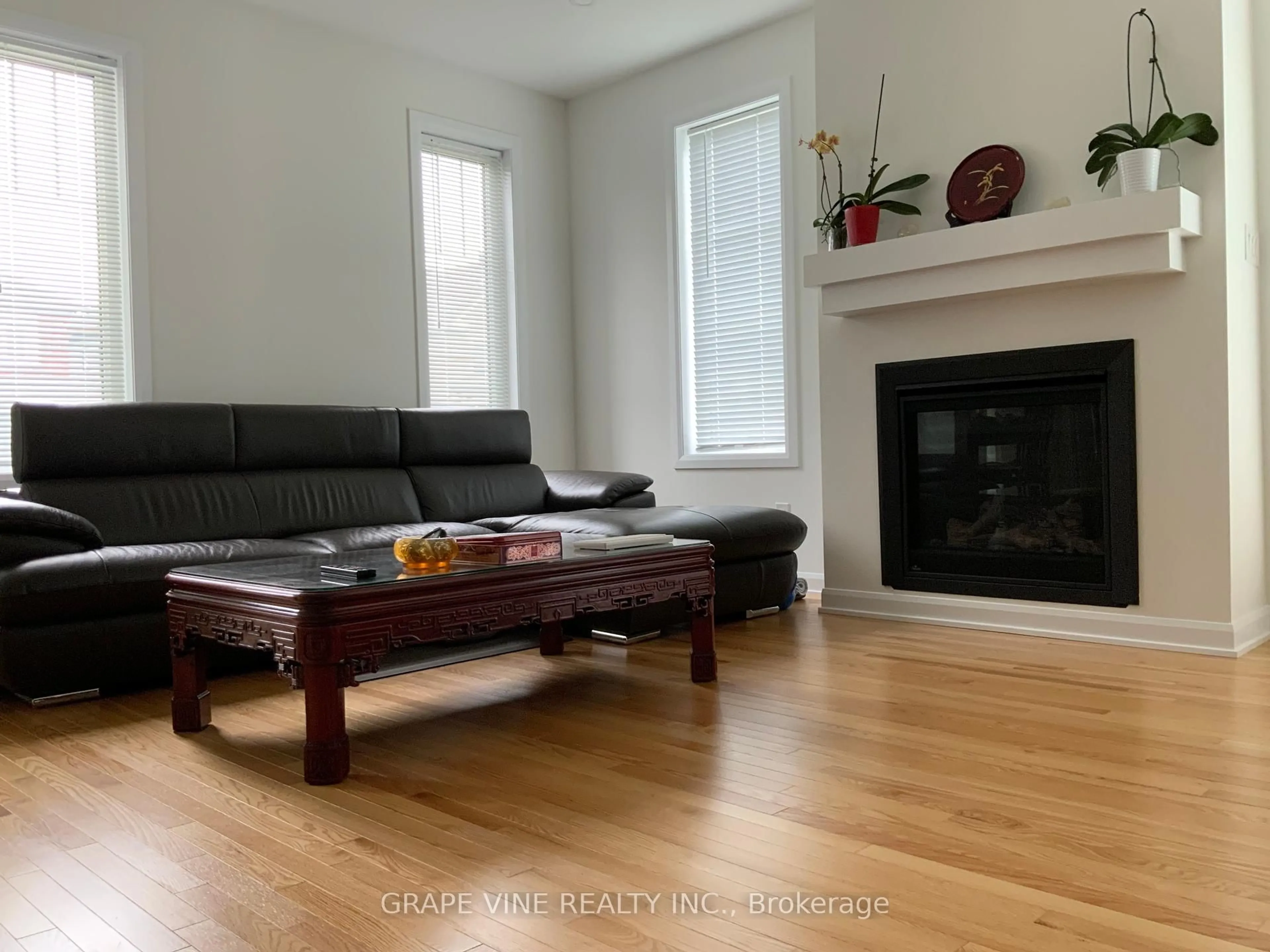 Living room with furniture, wood/laminate floor for 22 Dalkey Way, Ottawa Ontario K2J 6V5