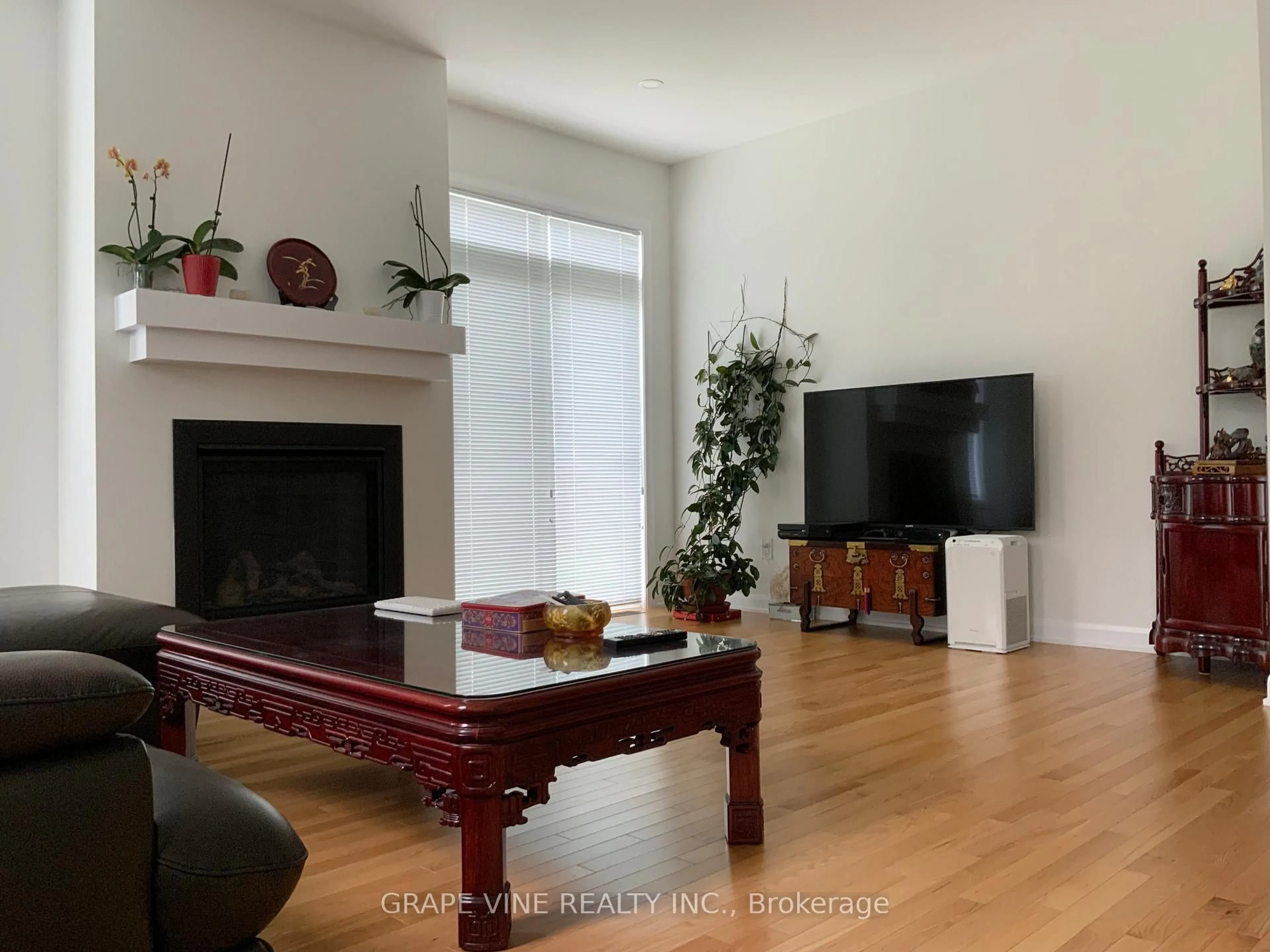 Living room with furniture, wood/laminate floor for 22 Dalkey Way, Ottawa Ontario K2J 6V5