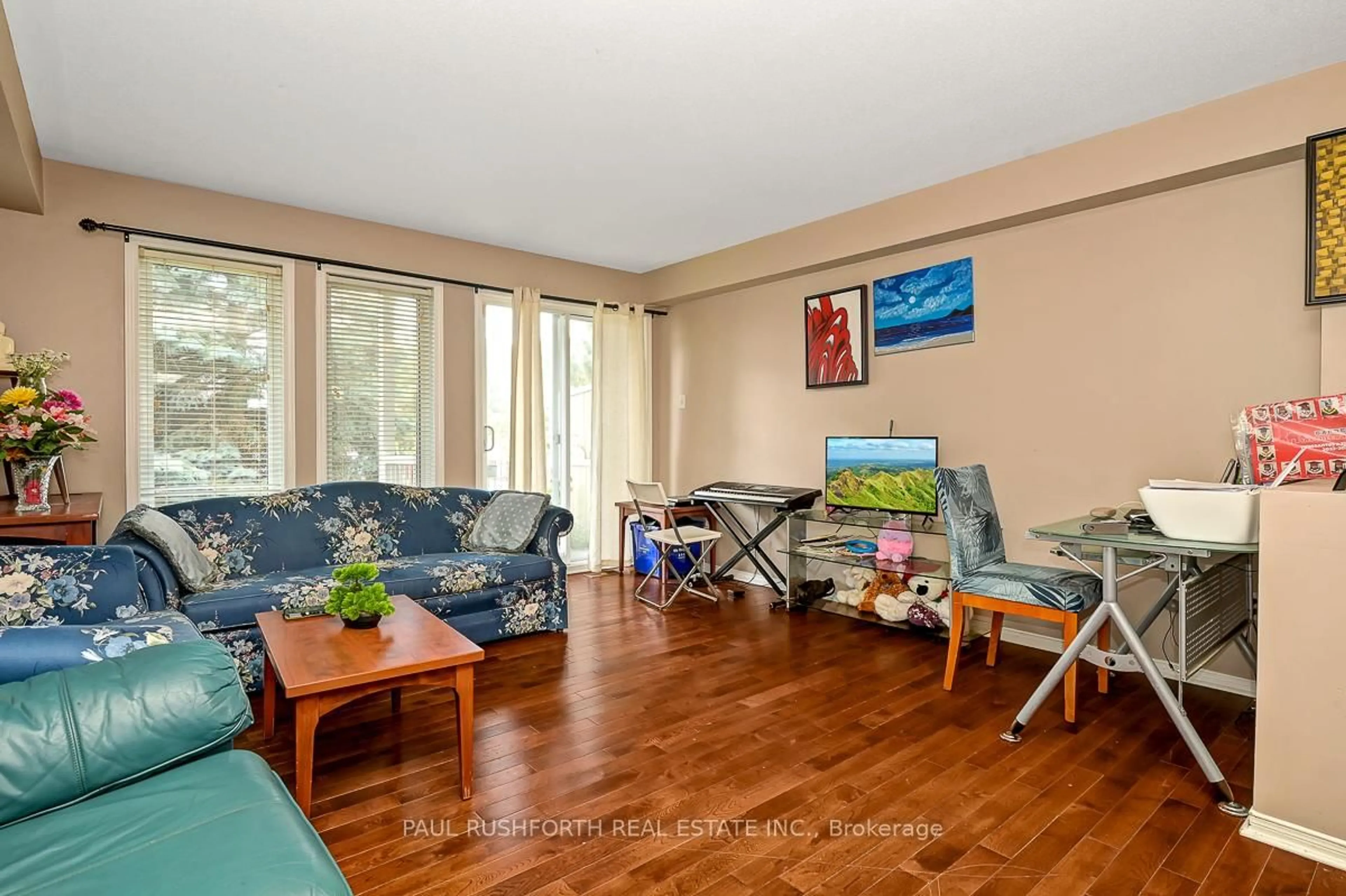 Living room with furniture, wood/laminate floor for 2232 Bois Vert Pl, Ottawa Ontario K4A 4T7