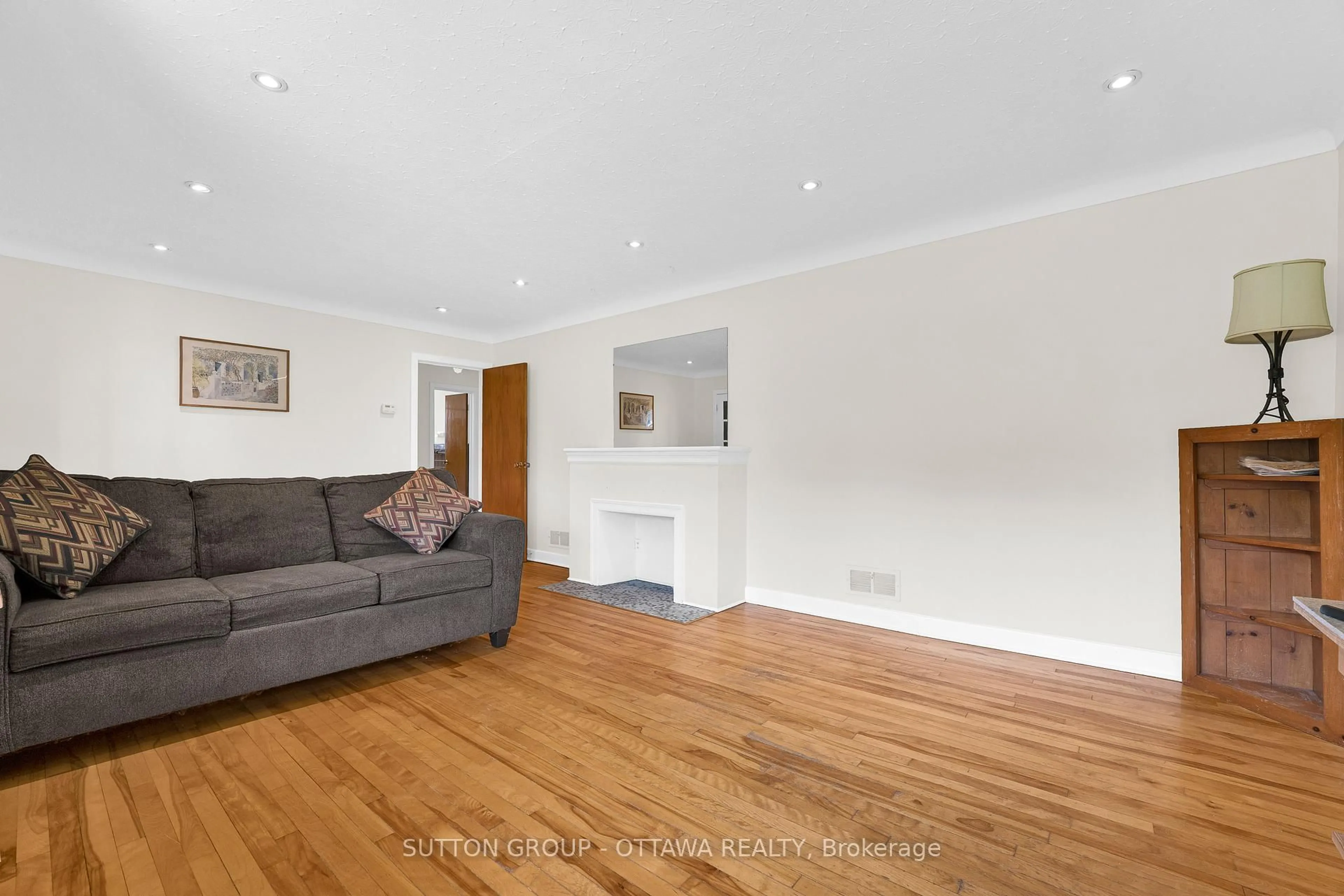 Living room with furniture, wood/laminate floor for 15 Granton Ave, Ottawa Ontario K2G 1W5