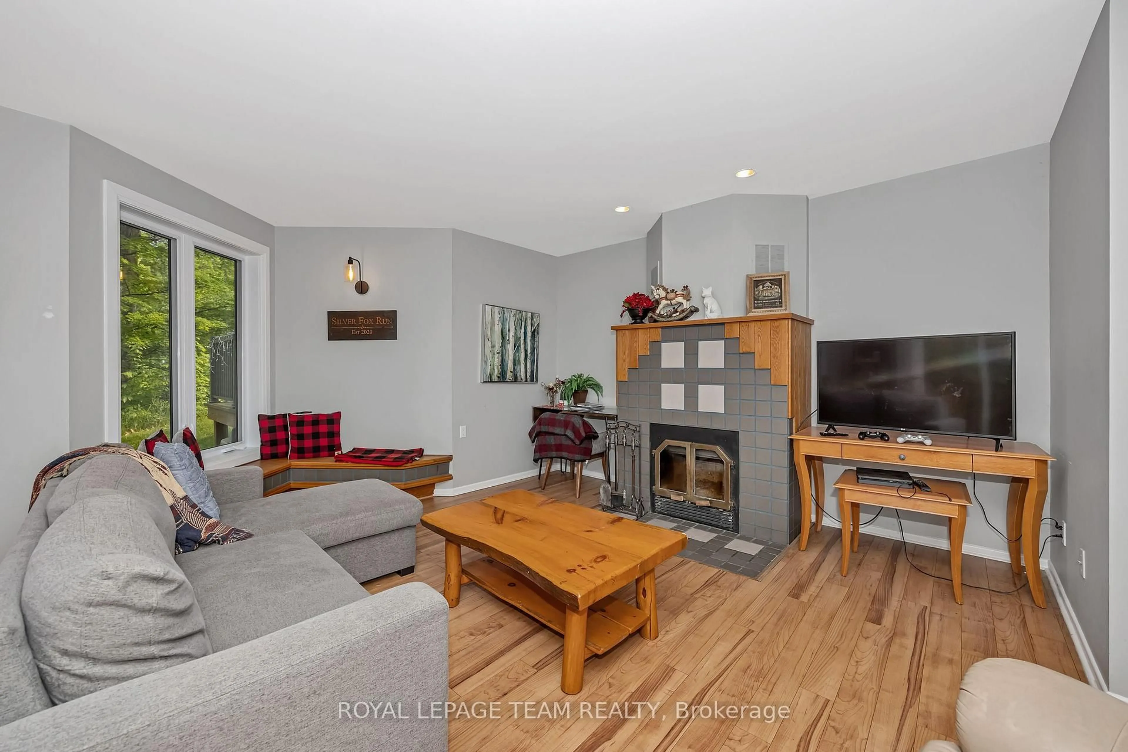Living room with furniture, wood/laminate floor for 65 Mary Joanne Dr #203, Calabogie Ontario K0J 1H0