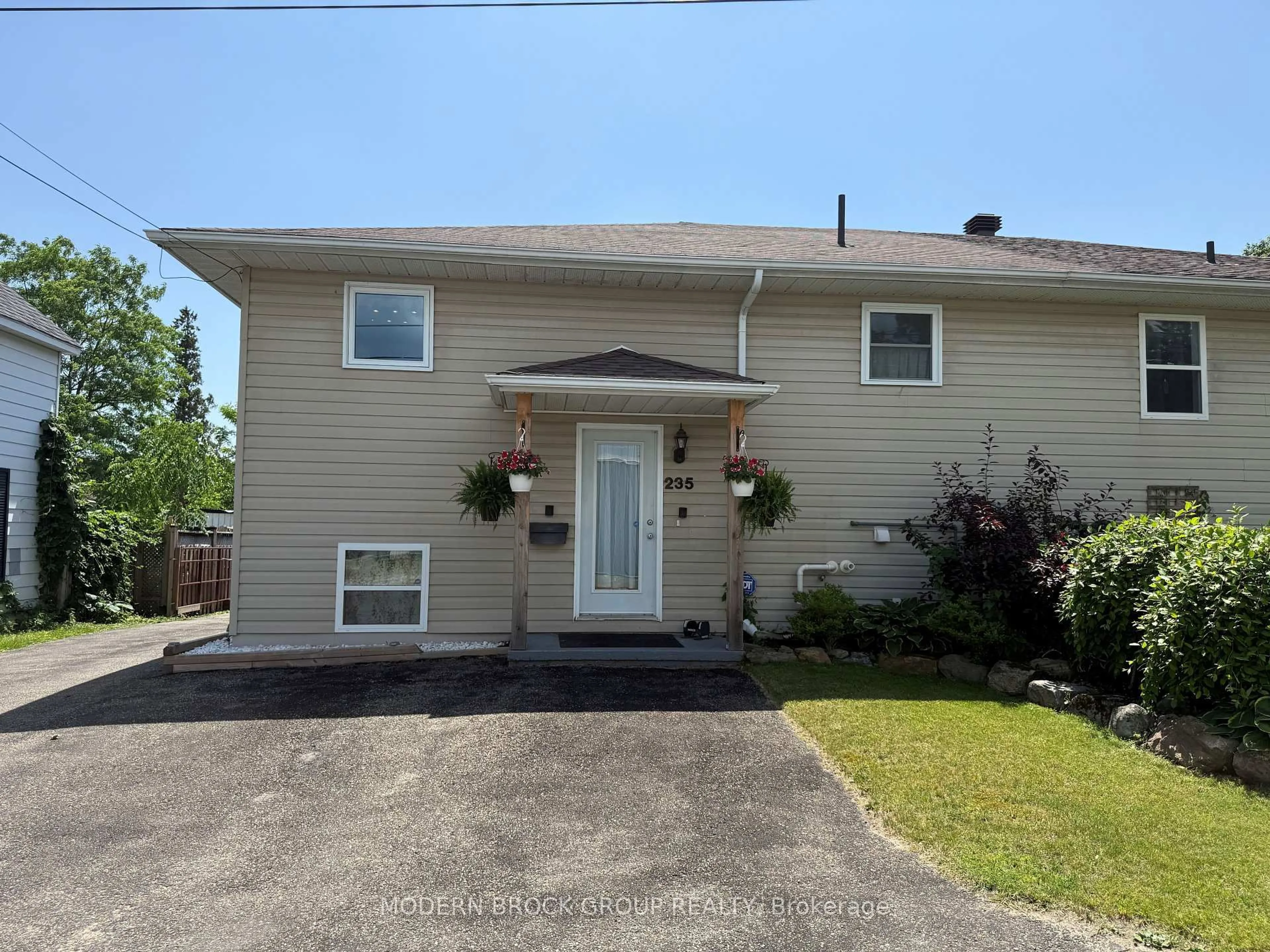 Home with vinyl exterior material, street for 235 Wood St, Prescott Ontario K0E 1T0