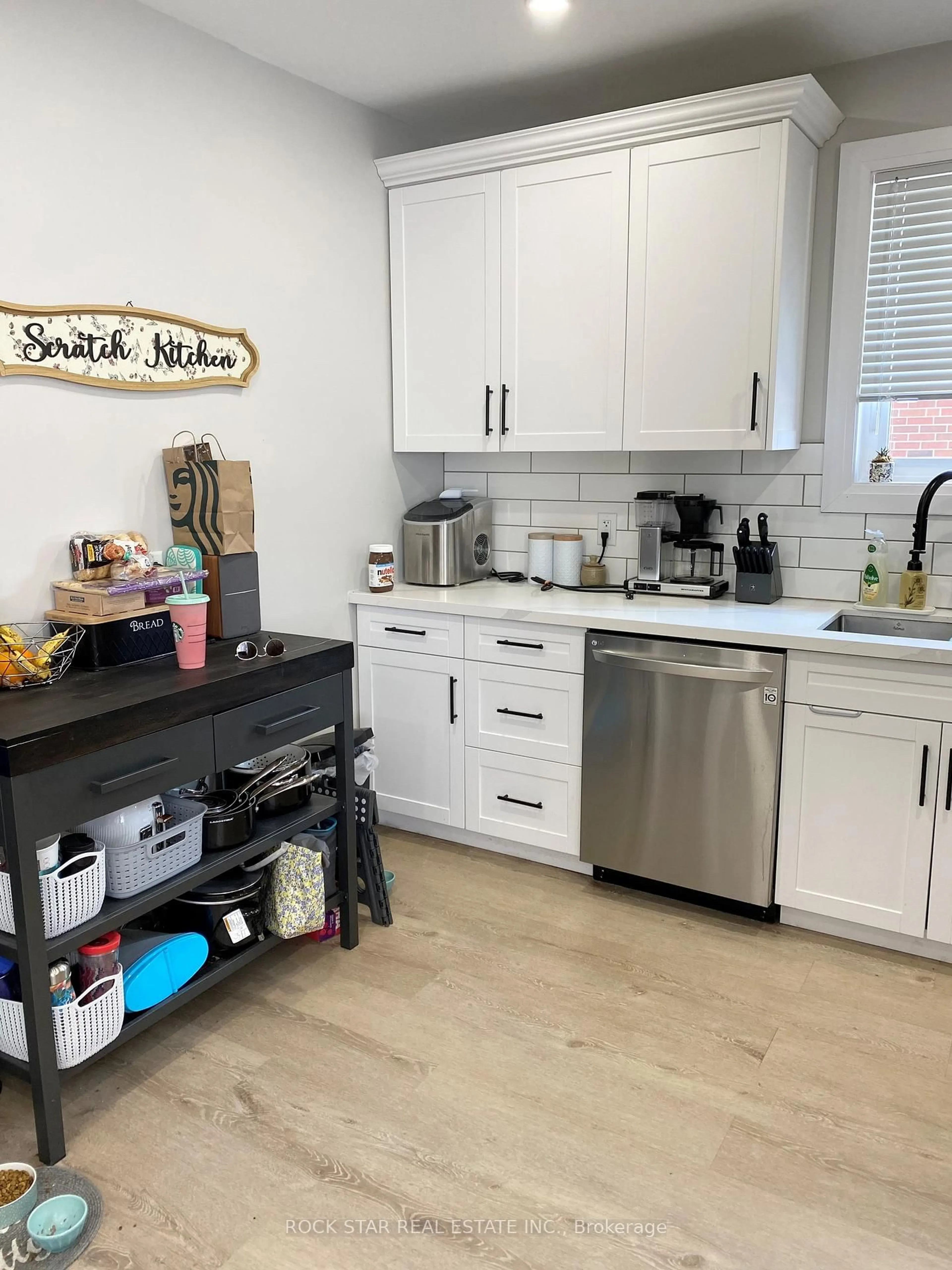 Open concept kitchen, wood/laminate floor for 889 Fennell Ave, Hamilton Ontario L8V 1W5
