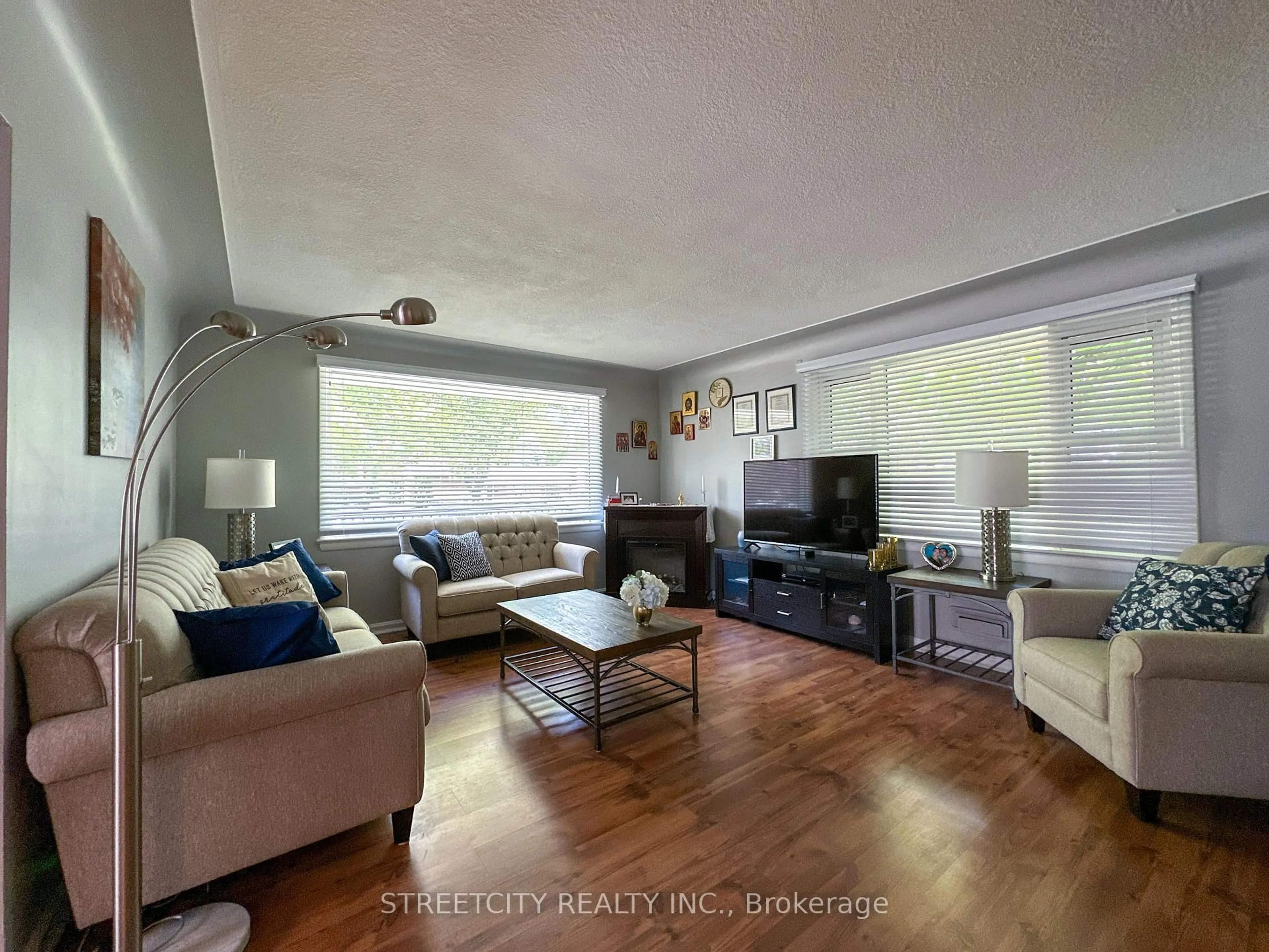 Living room with furniture, wood/laminate floor for 1025 Kensington Blvd, Sarnia Ontario N7S 1N3