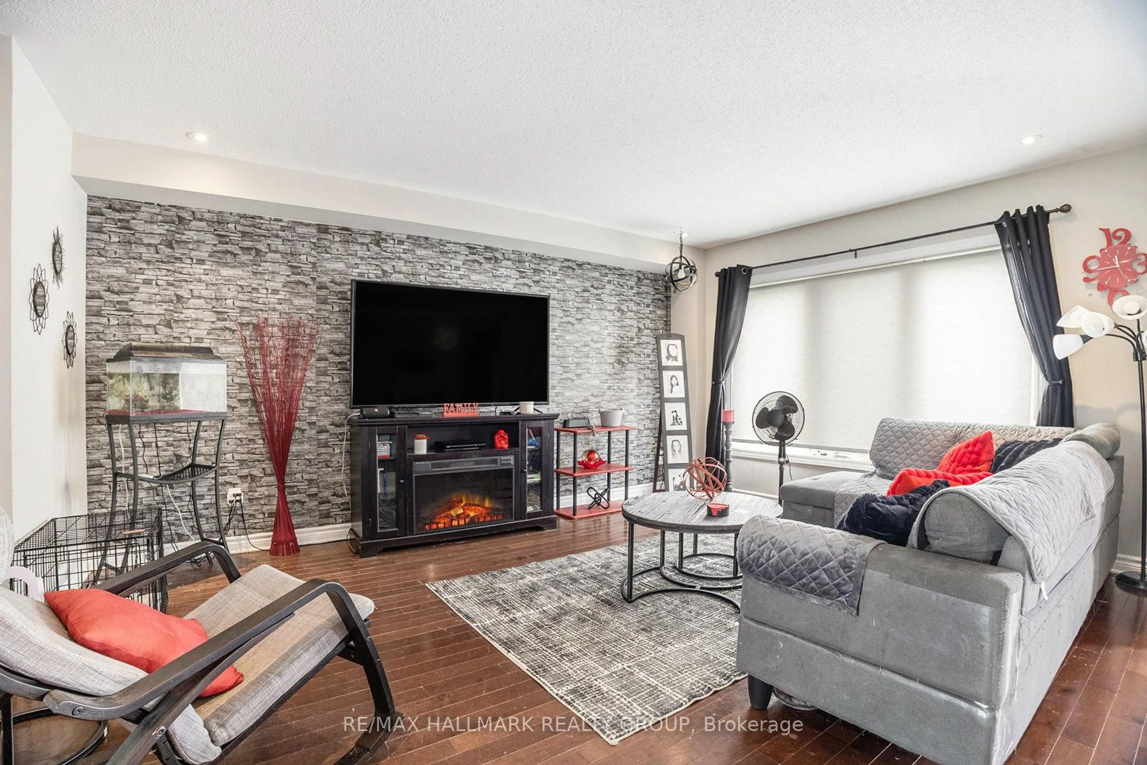 Living room with furniture, wood/laminate floor for 6349 Renaud Rd, Ottawa Ontario K1W 0J4