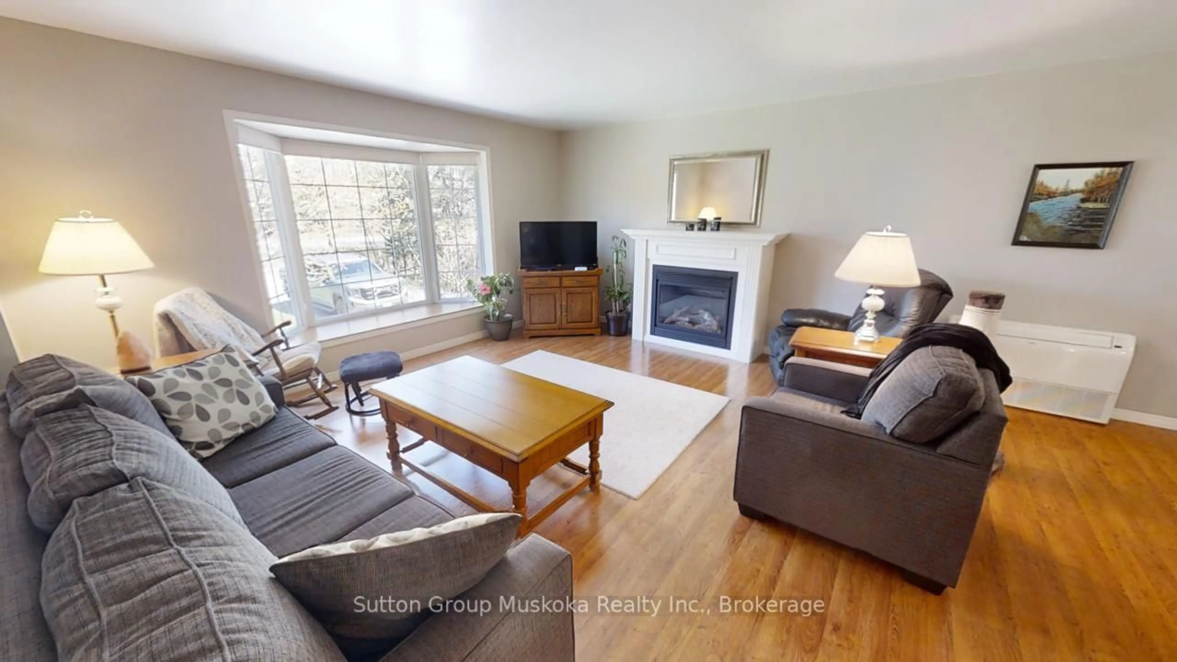 Living room with furniture, wood/laminate floor for 357 RAVENSCLIFFE Rd, Huntsville Ontario P1H 1L6