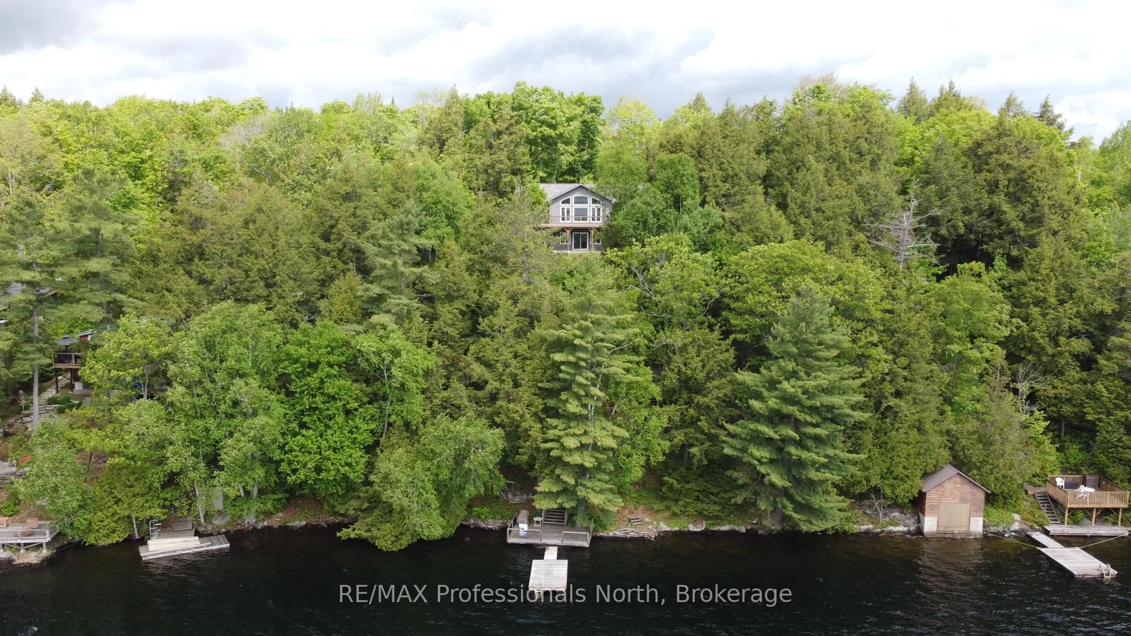 A pic from outside/outdoor area/front of a property/back of a property/a pic from drone, water/lake/river/ocean view for 5997 Kennisis Lake Rd, Dysart et al Ontario K0M 1S0