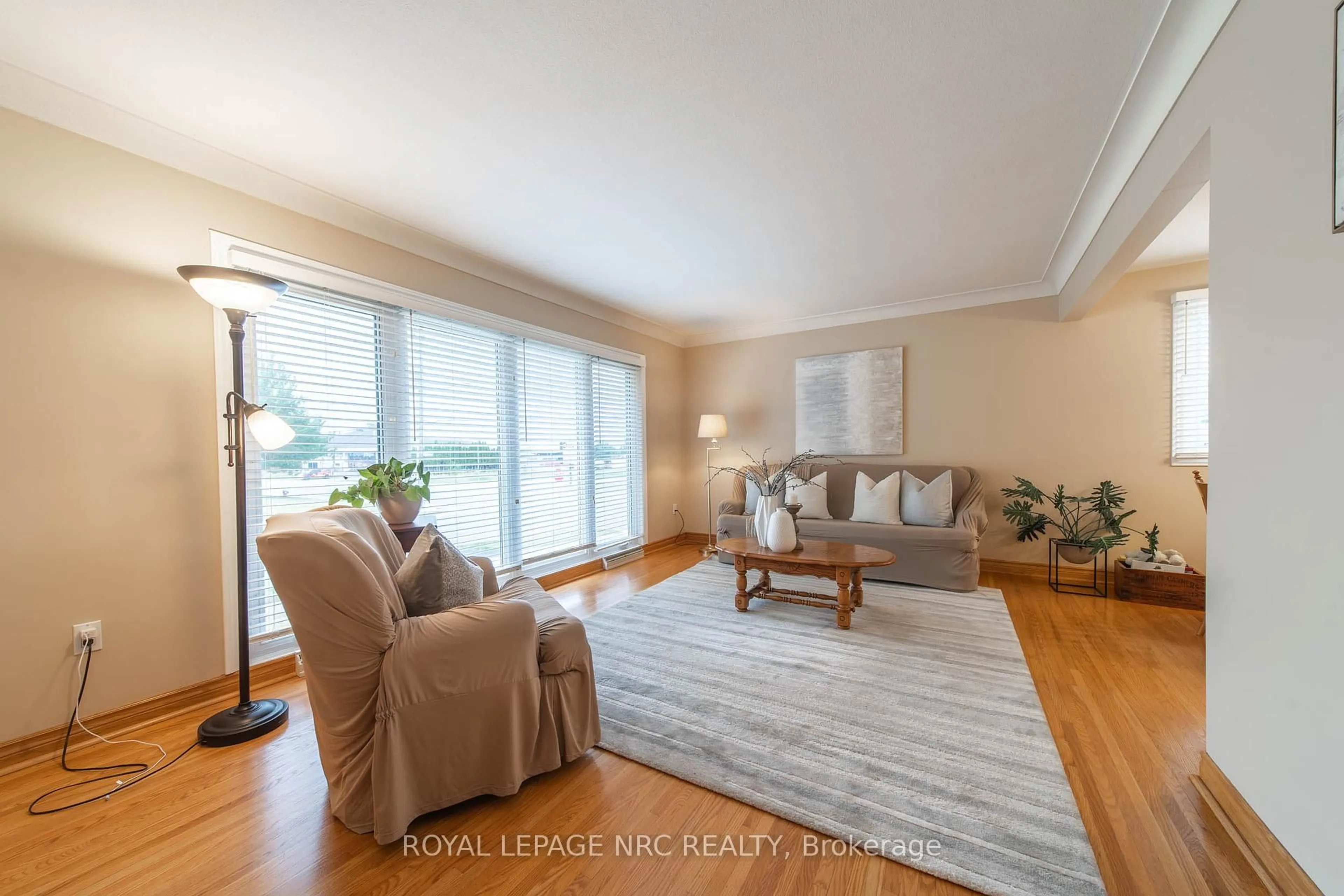 Living room with furniture, wood/laminate floor for 6246 Glengate St, Niagara Falls Ontario L2E 5S3