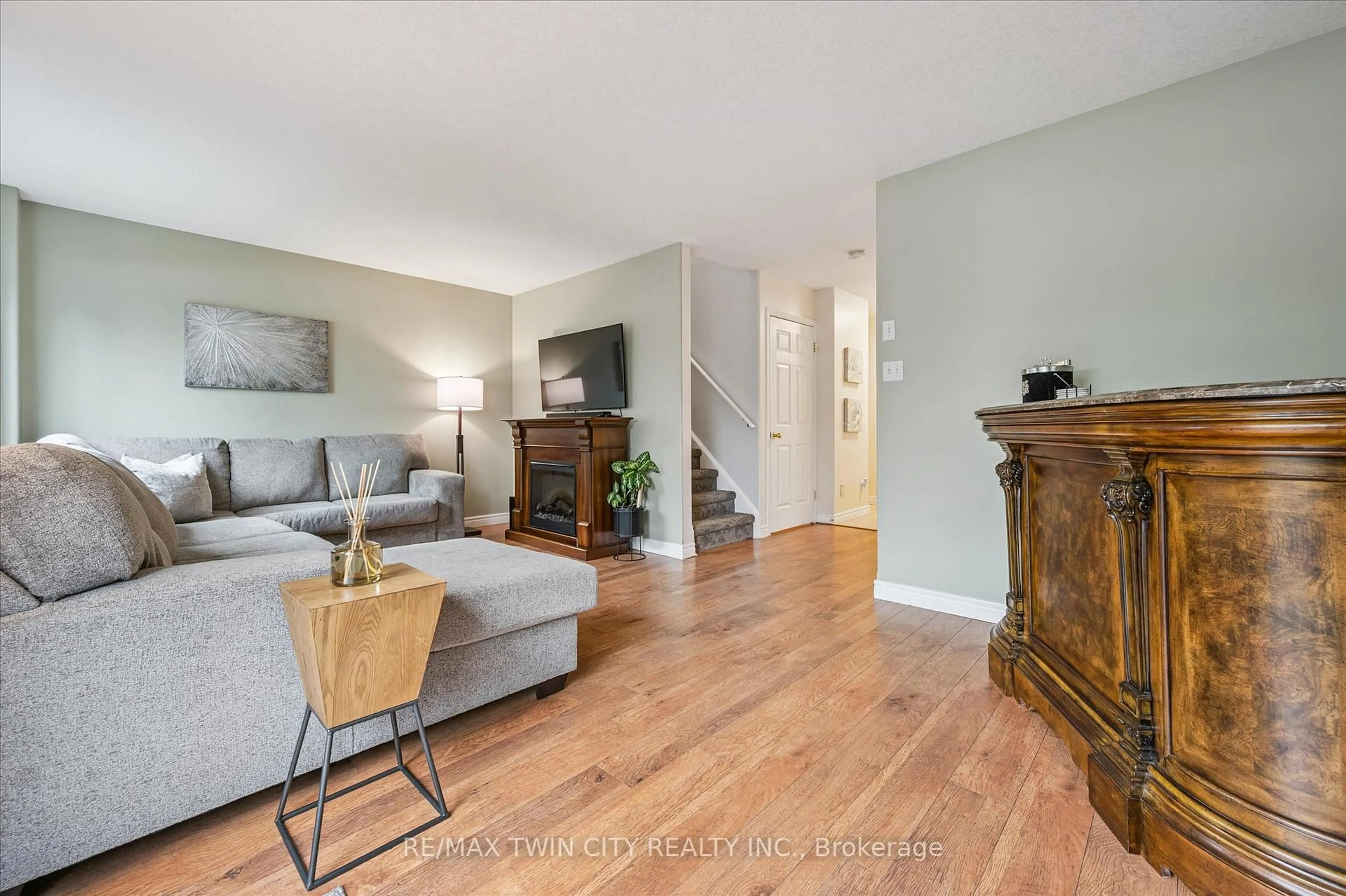 Living room with furniture, wood/laminate floor for 49 Porchlight Dr, Woolwich Ontario N3B 3M7