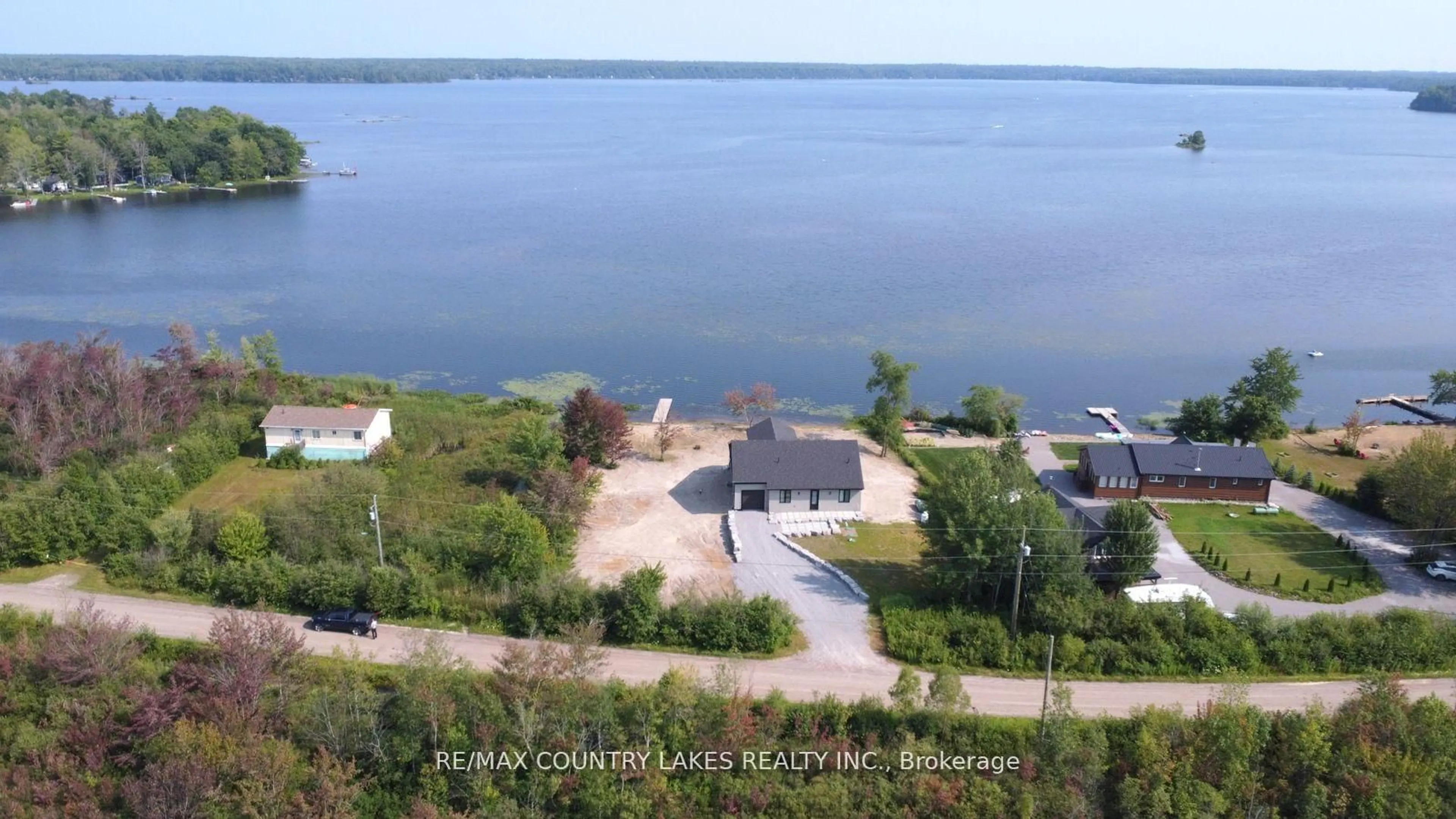 A pic from outside/outdoor area/front of a property/back of a property/a pic from drone, water/lake/river/ocean view for 130 Baker Blvd, Kawartha Lakes Ontario K0M 2B0