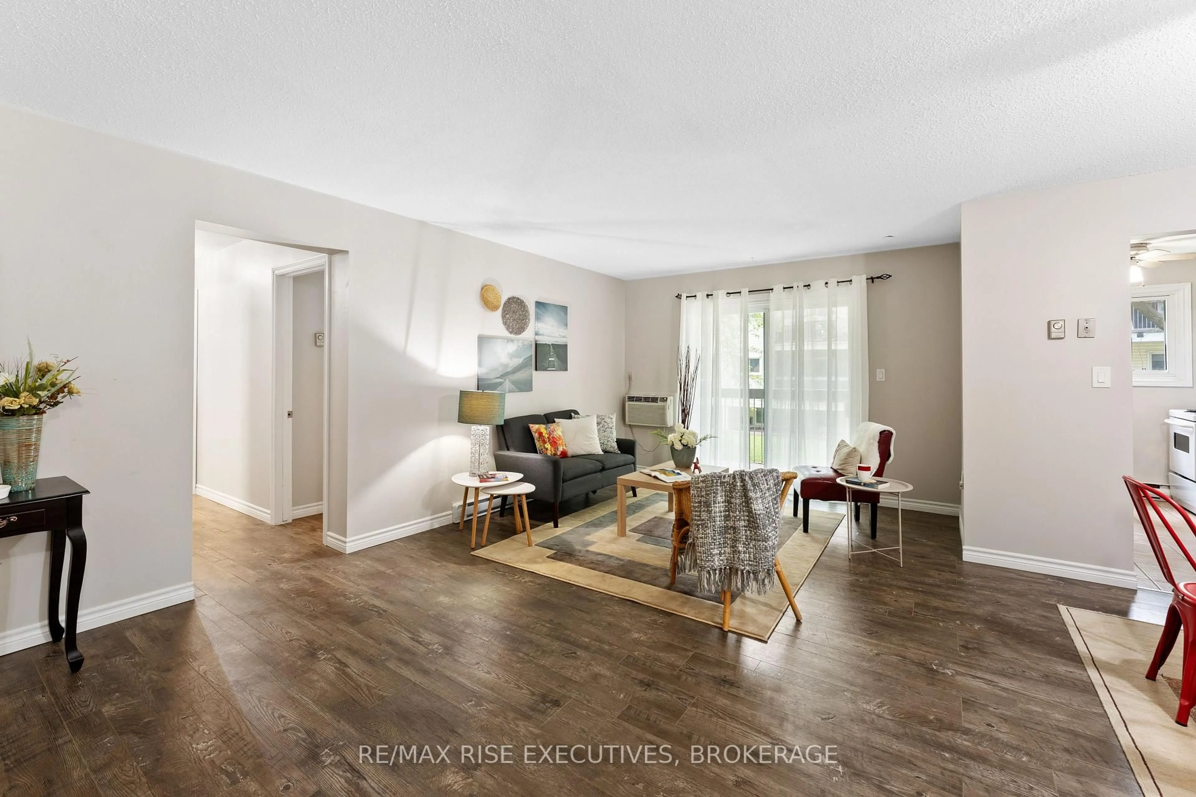 Living room with furniture, wood/laminate floor for 845 Milford Dr #201, Kingston Ontario K7P 1A7