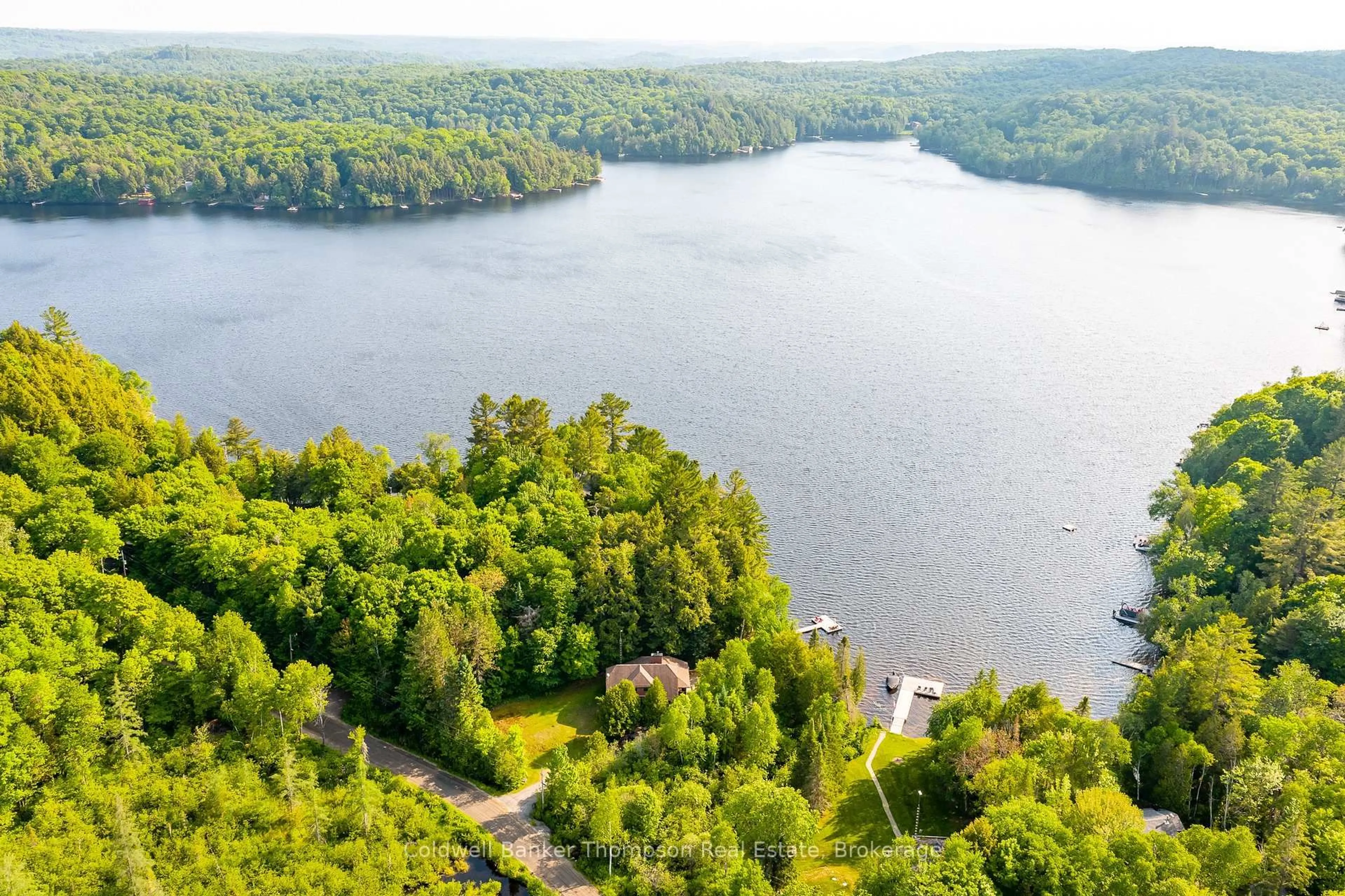 A pic from outside/outdoor area/front of a property/back of a property/a pic from drone, water/lake/river/ocean view for 215 Ena Dr, Huntsville Ontario P1H 2J4