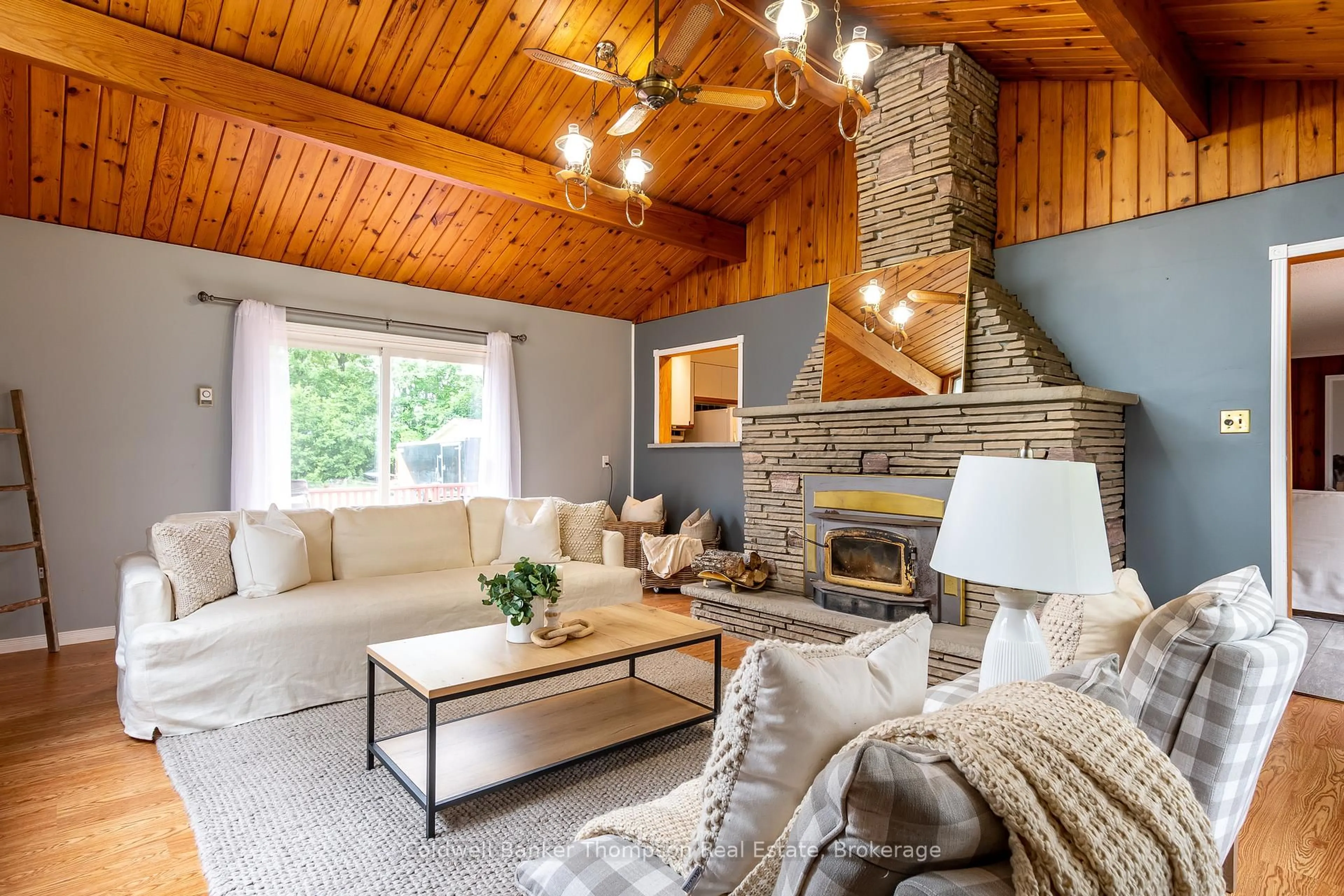 Living room with furniture, wood/laminate floor for 4242 Ravenscliffe Rd, Huntsville Ontario P1H 2J2