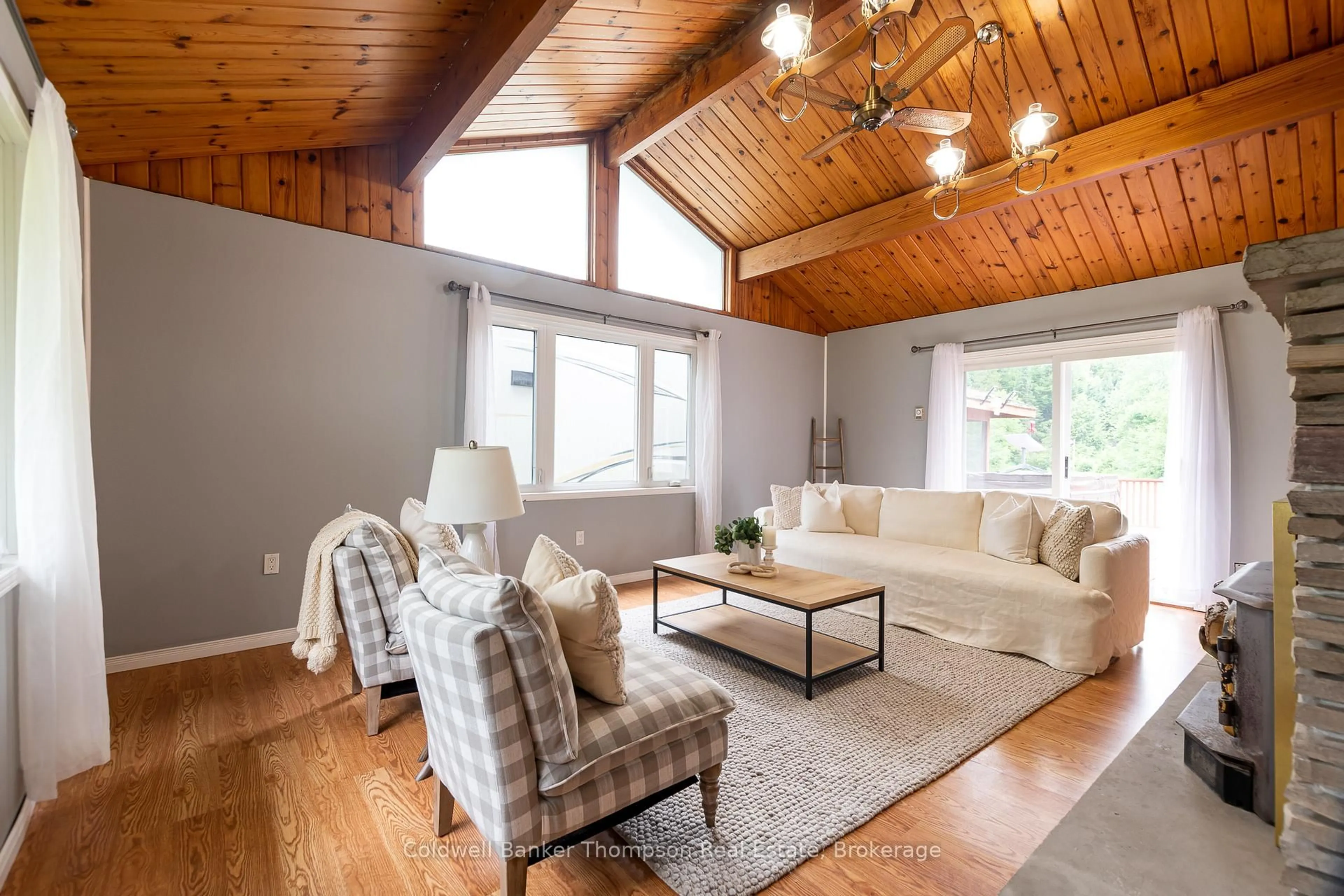 Living room with furniture, wood/laminate floor for 4242 Ravenscliffe Rd, Huntsville Ontario P1H 2J2