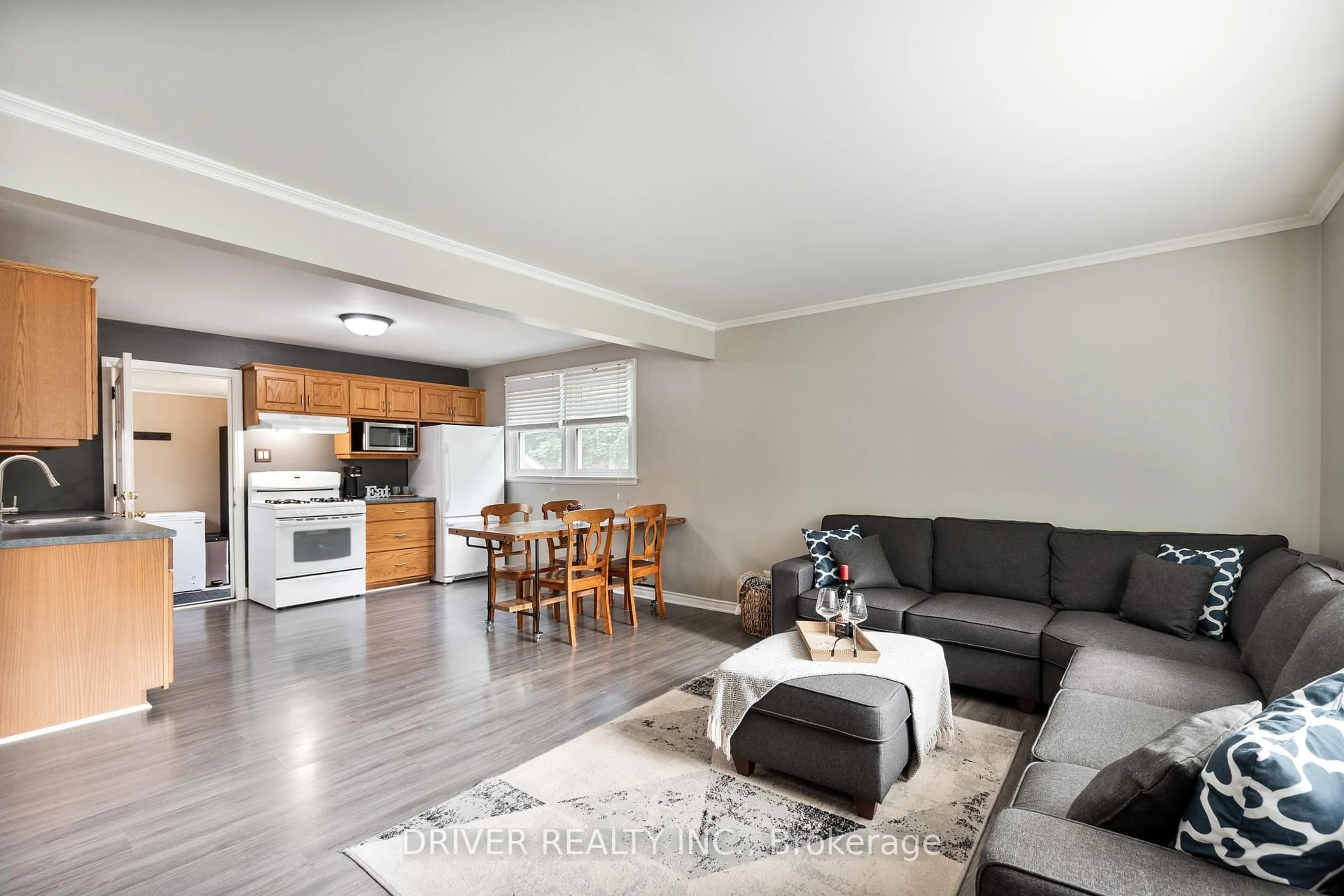 Living room with furniture, wood/laminate floor for 64 Caverly Rd, Aylmer Ontario N5H 2P4