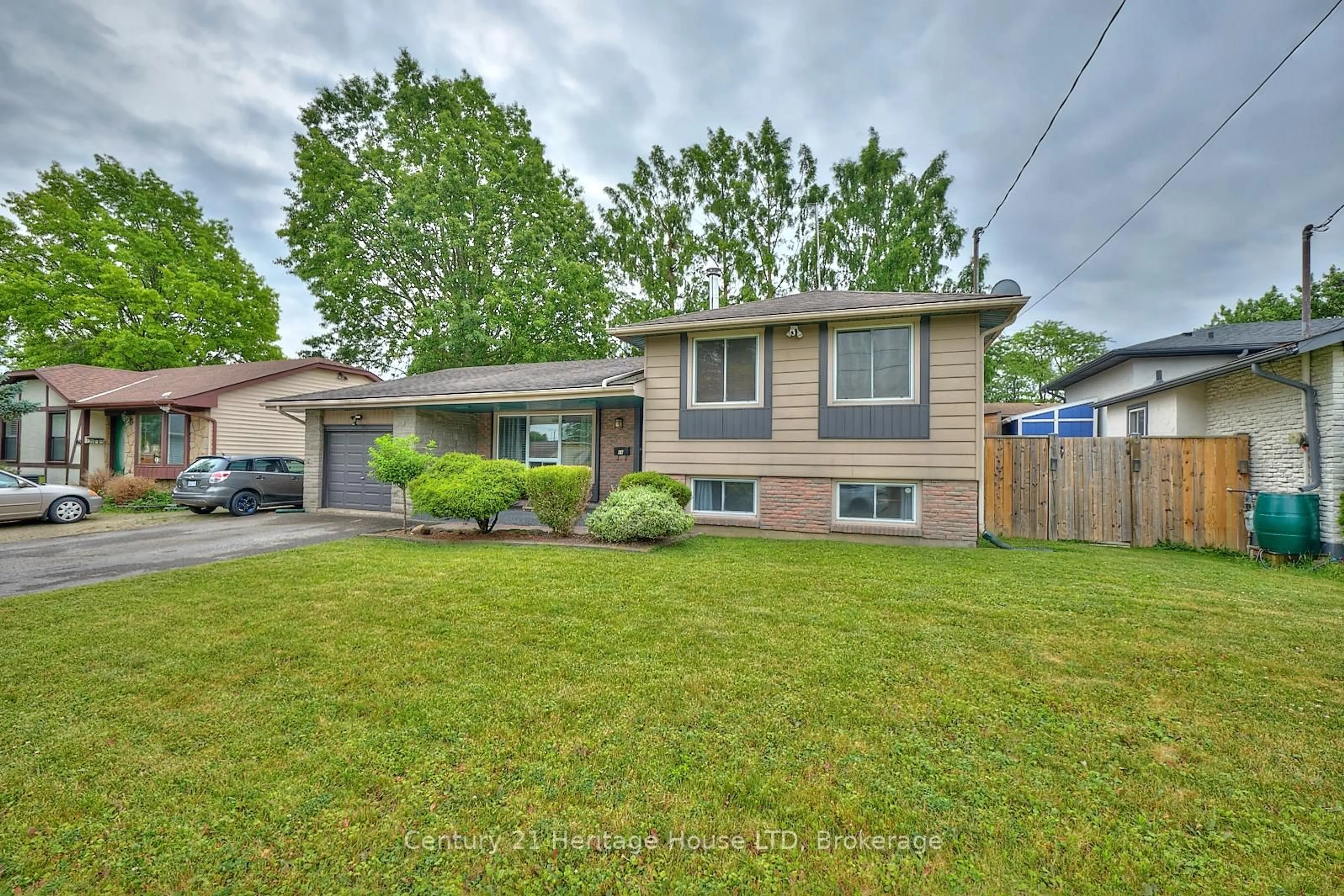 Home with brick exterior material, street for 64 Rockwood Ave, St. Catharines Ontario L2P 1E9