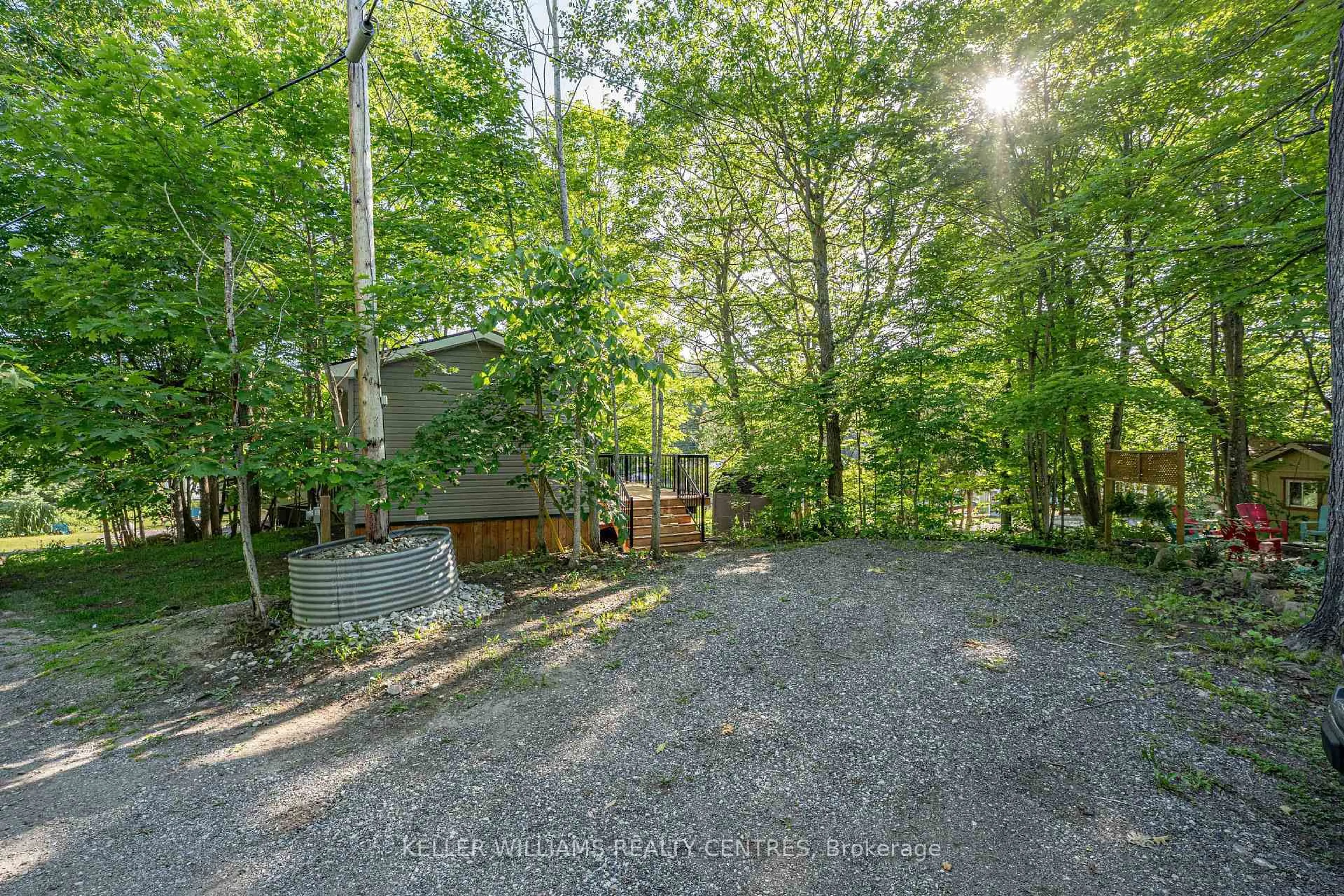 A pic from outside/outdoor area/front of a property/back of a property/a pic from drone, forest/trees view for 202 Hidden Glen Rd ##94, Georgian Bay Ontario L0K 1S0