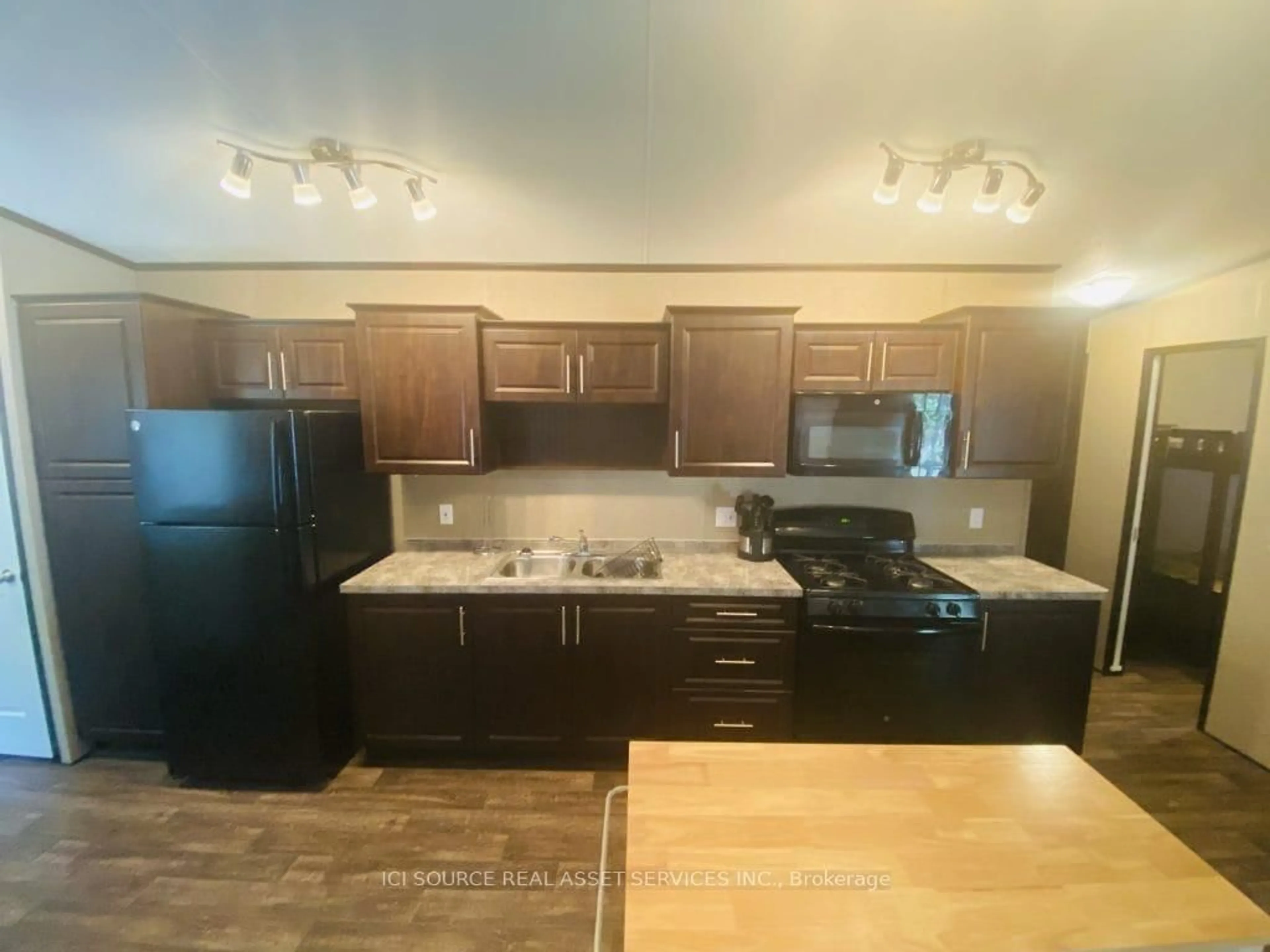 Open concept kitchen, wood/laminate floor for 1082 Shamrock Marina Rd #229, Gravenhurst Ontario P0E 1N0