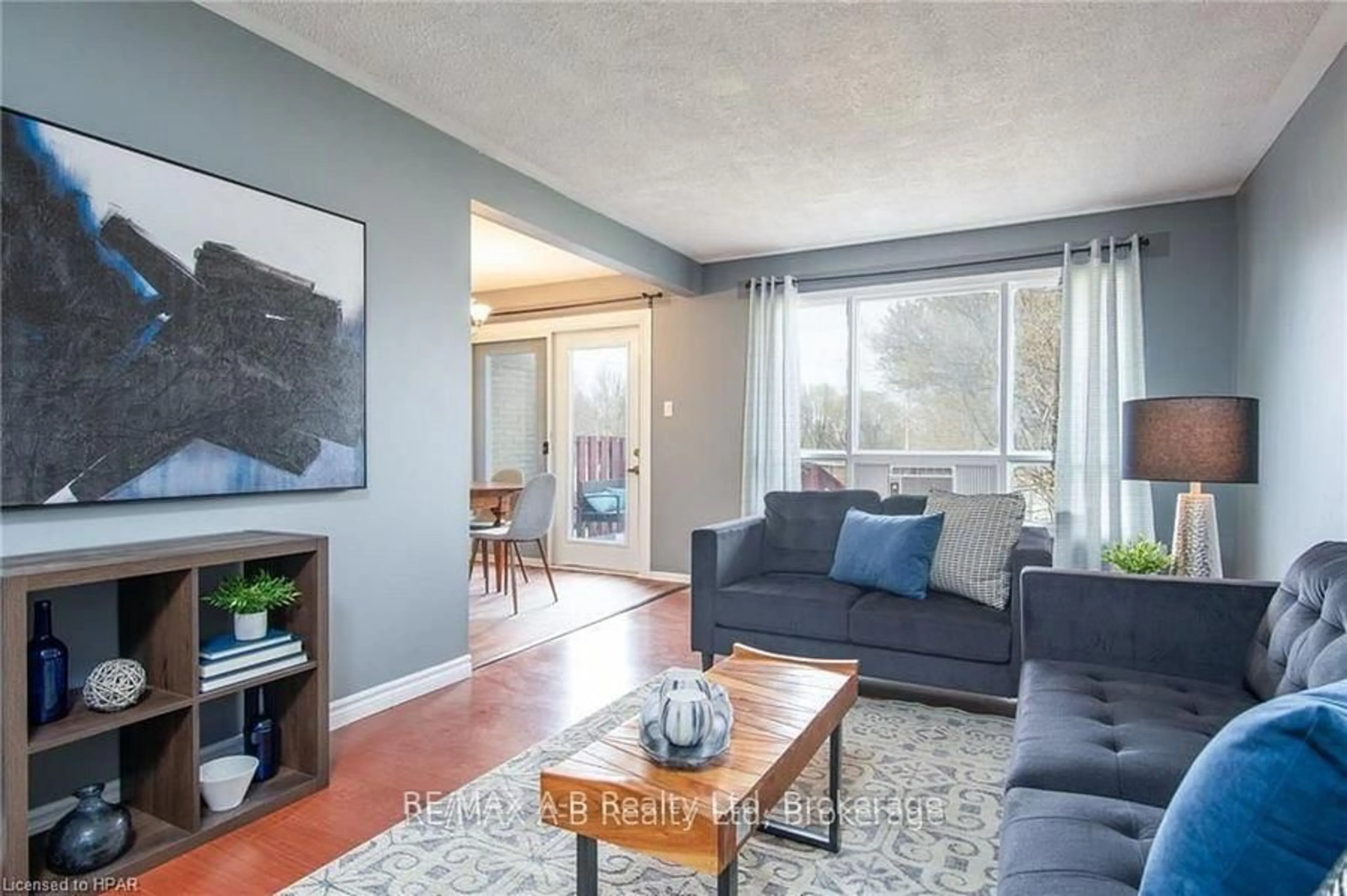 Living room with furniture, wood/laminate floor for 26 Dickens Pl, Stratford Ontario N5A 7G1