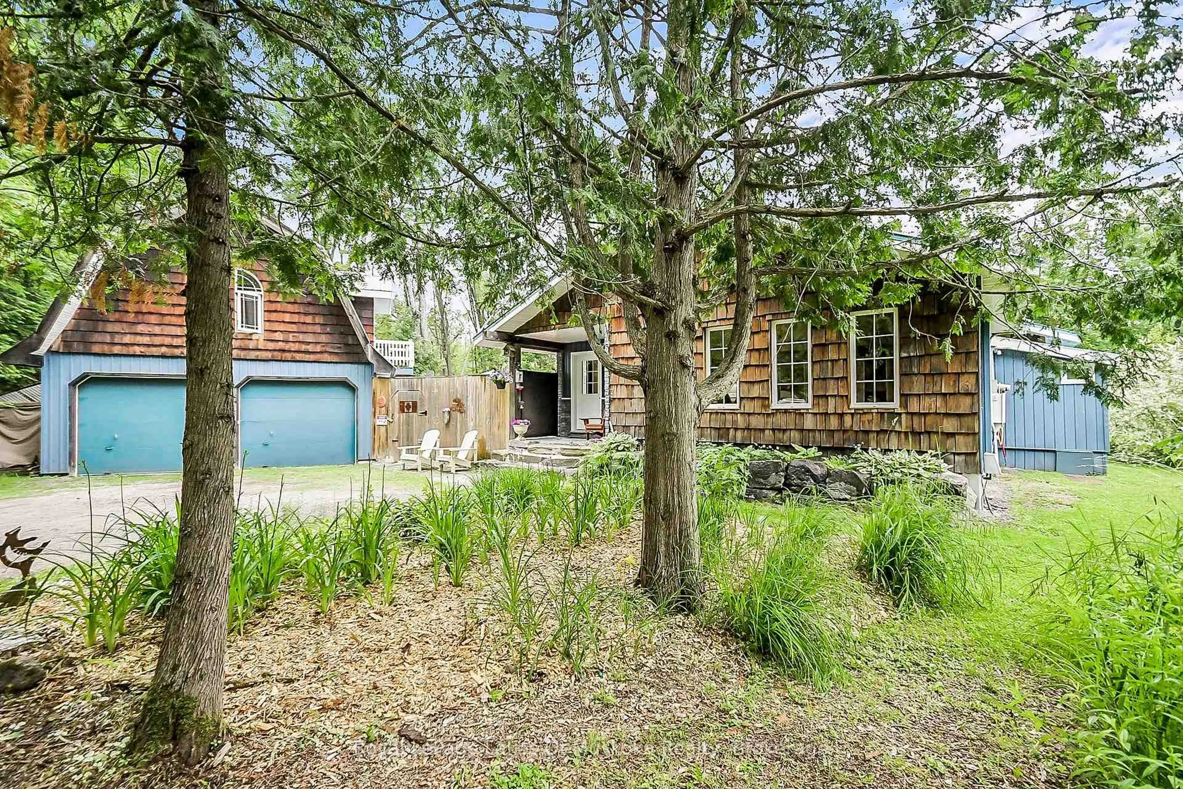 A pic from outside/outdoor area/front of a property/back of a property/a pic from drone, forest/trees view for 1005 Kirby's Beach Rd, Bracebridge Ontario P1L 1X2